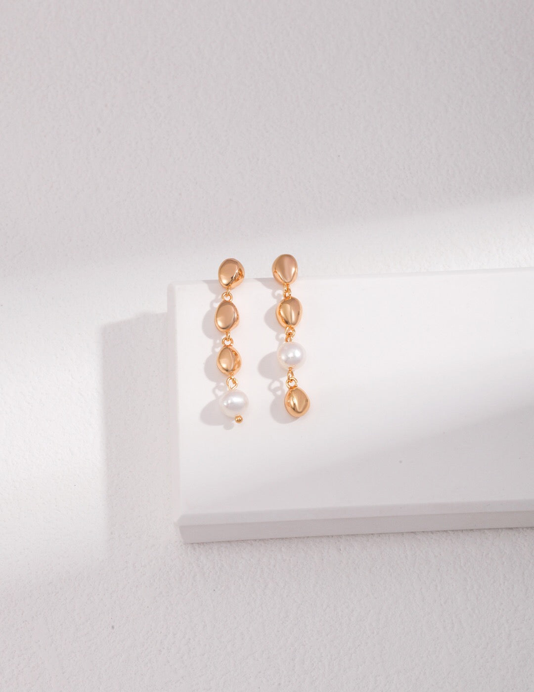 Elegant Bean and Pearl Cascade Earrings featuring freshwater pearls and sterling silver with gold vermeil plating.