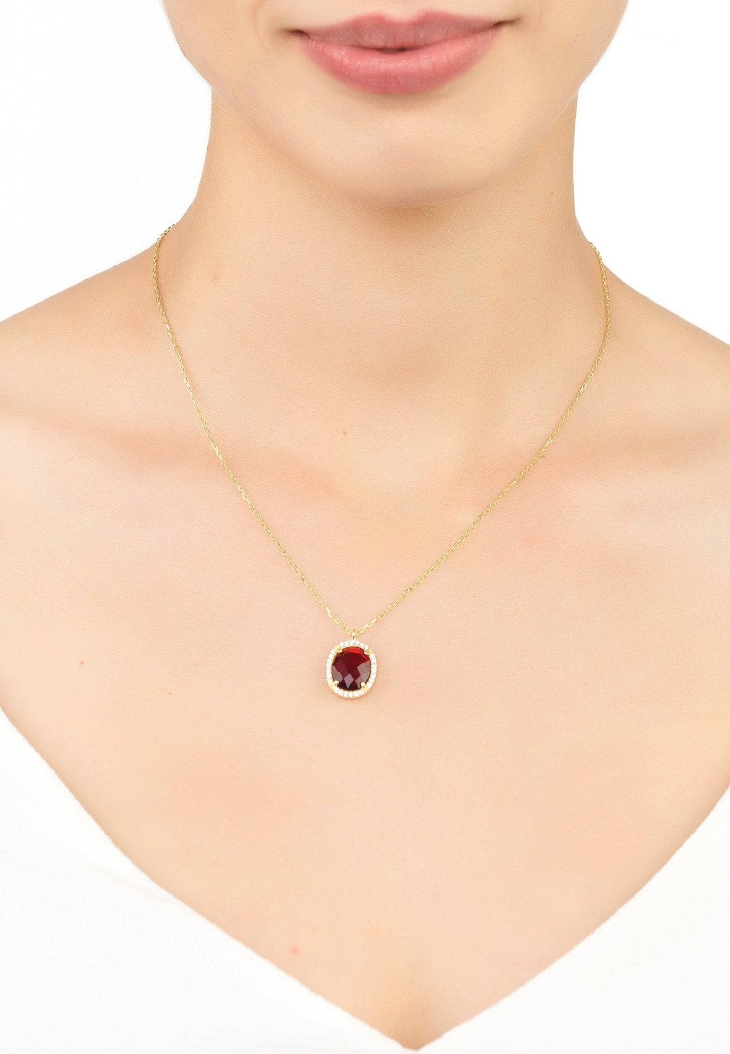 Beatrice Oval Gemstone Pendant Necklace featuring a garnet gemstone in a gold setting with Cubic Zirconia accents.