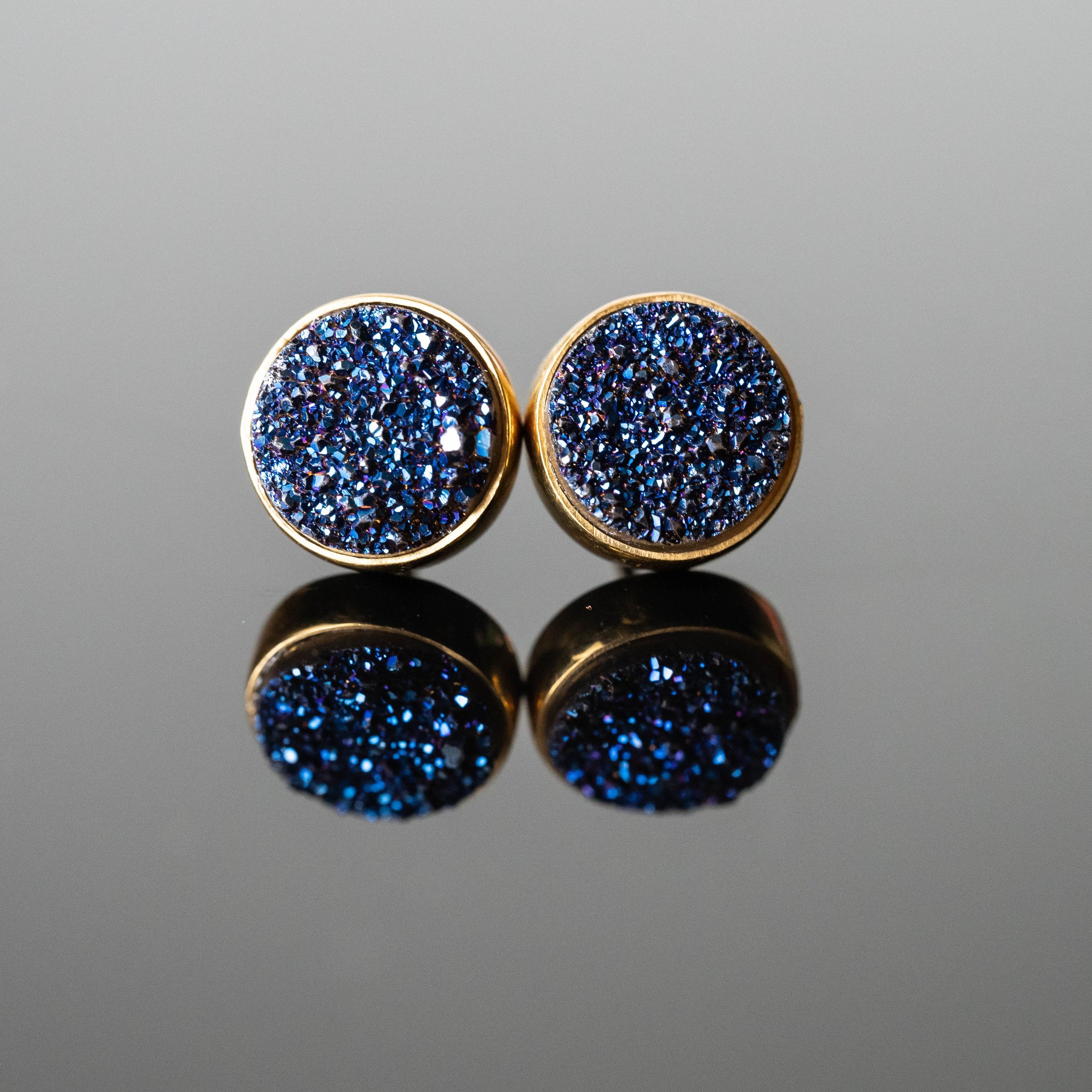 Beatriz Druzy Round Studs featuring blue druzy stones set in gold-plated sterling silver, showcasing their unique sparkle and elegance.