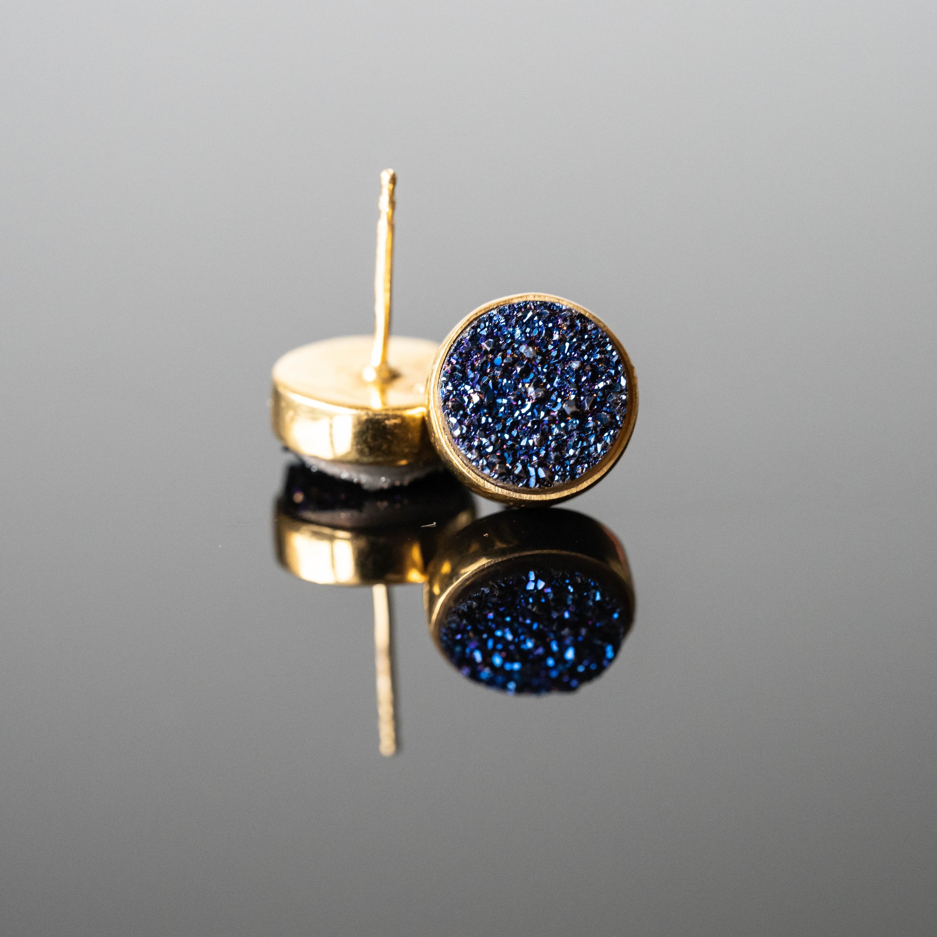 Beatriz Druzy Round Studs featuring blue druzy stones set in gold-plated sterling silver, showcasing their unique sparkle and elegance.