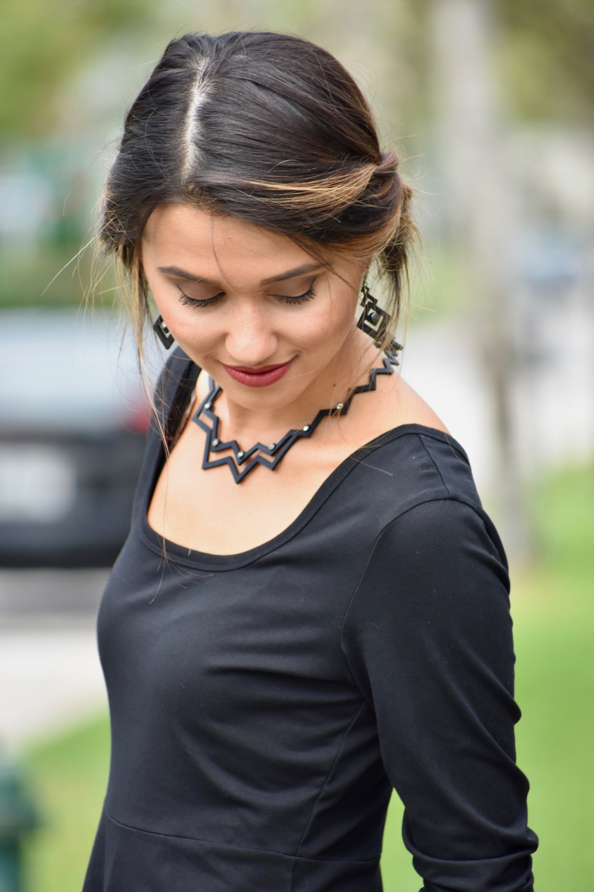 A pair of beautiful earrings displayed elegantly in a velvet pouch, showcasing their unique design and craftsmanship.