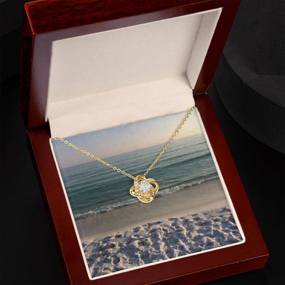 Beautiful Love Knot Necklace with cubic zirconia crystals, available in 14k white gold or 18k yellow gold over stainless steel.