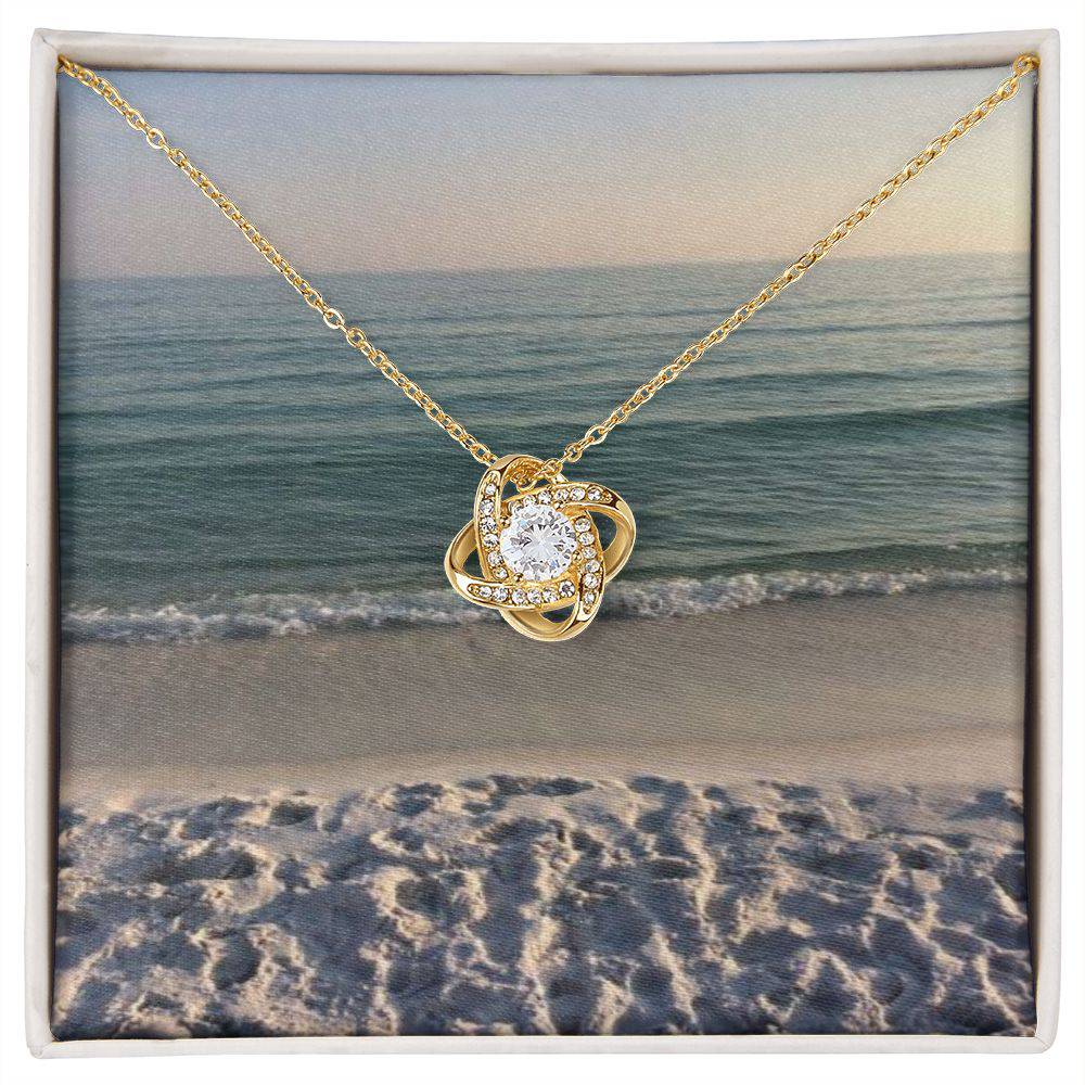 Beautiful Love Knot Necklace with cubic zirconia crystals, available in 14k white gold or 18k yellow gold over stainless steel.