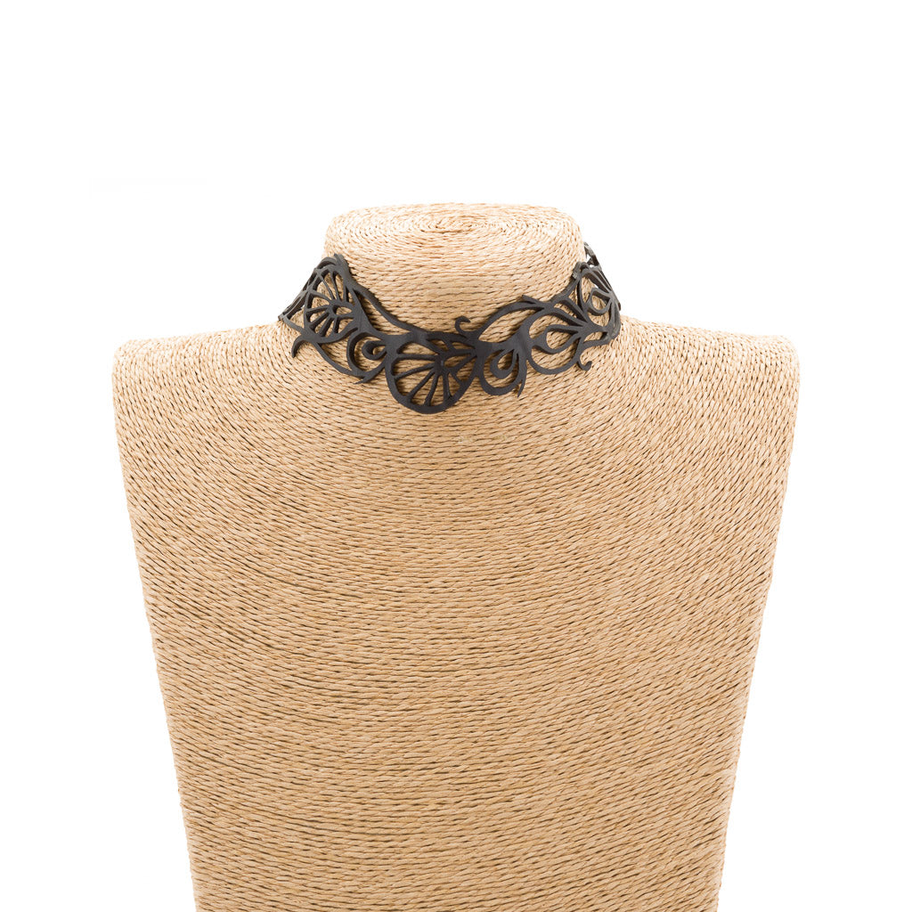 Bella Elegant Inner Tube Choker made from recycled rubber, featuring intricate handcrafted designs and adjustable button closures.