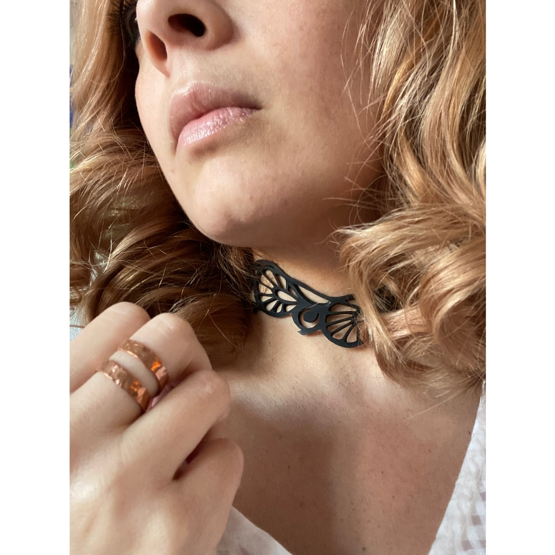 Bella Elegant Inner Tube Choker made from recycled rubber, featuring intricate handcrafted designs and adjustable button closures.