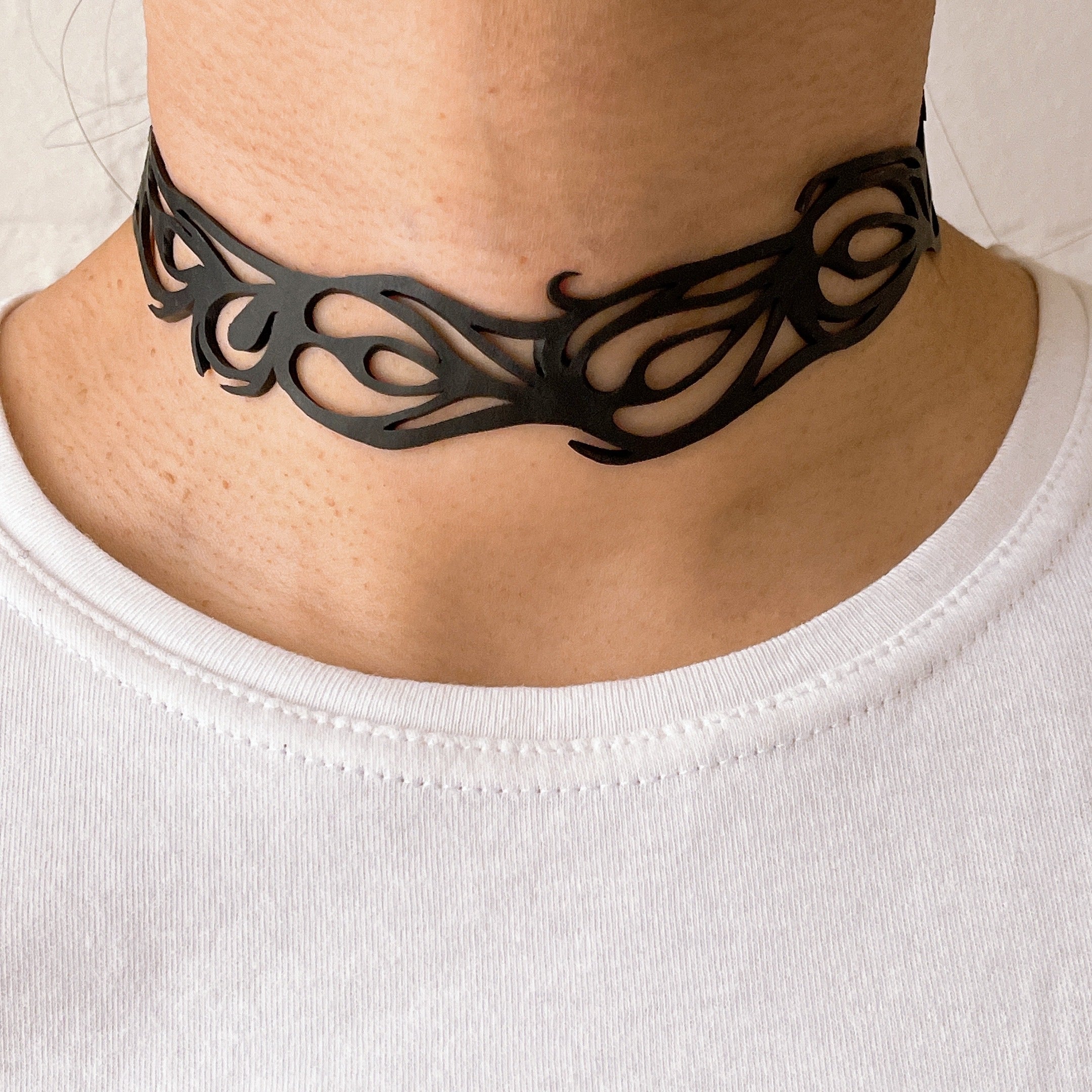 Bella Elegant Inner Tube Choker made from recycled rubber, featuring intricate handcrafted designs and adjustable button closures.