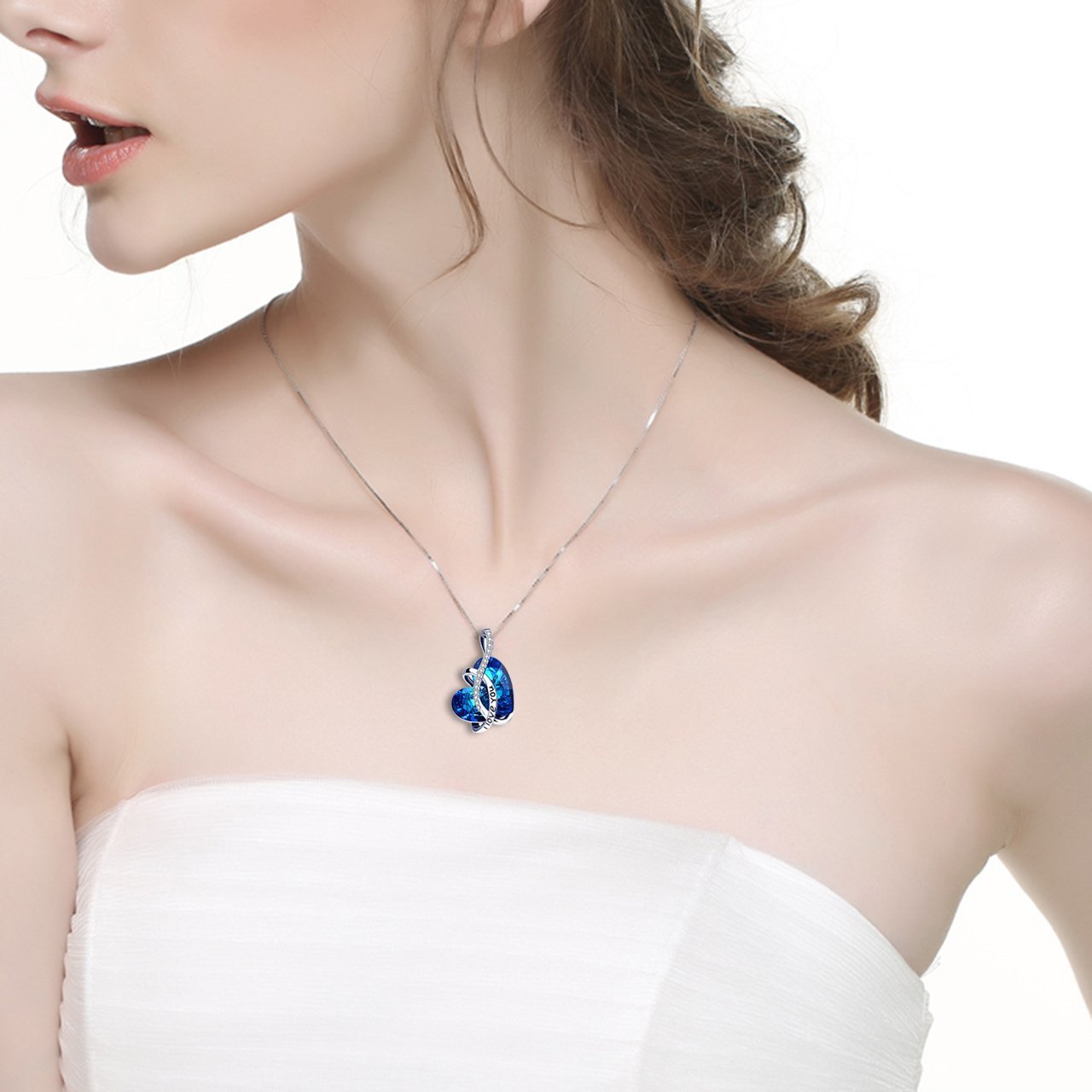 Bermuda Blue Elements 'I Love You Necklace' featuring a heart-shaped stone in 18K white gold plating, displayed elegantly on a soft background.