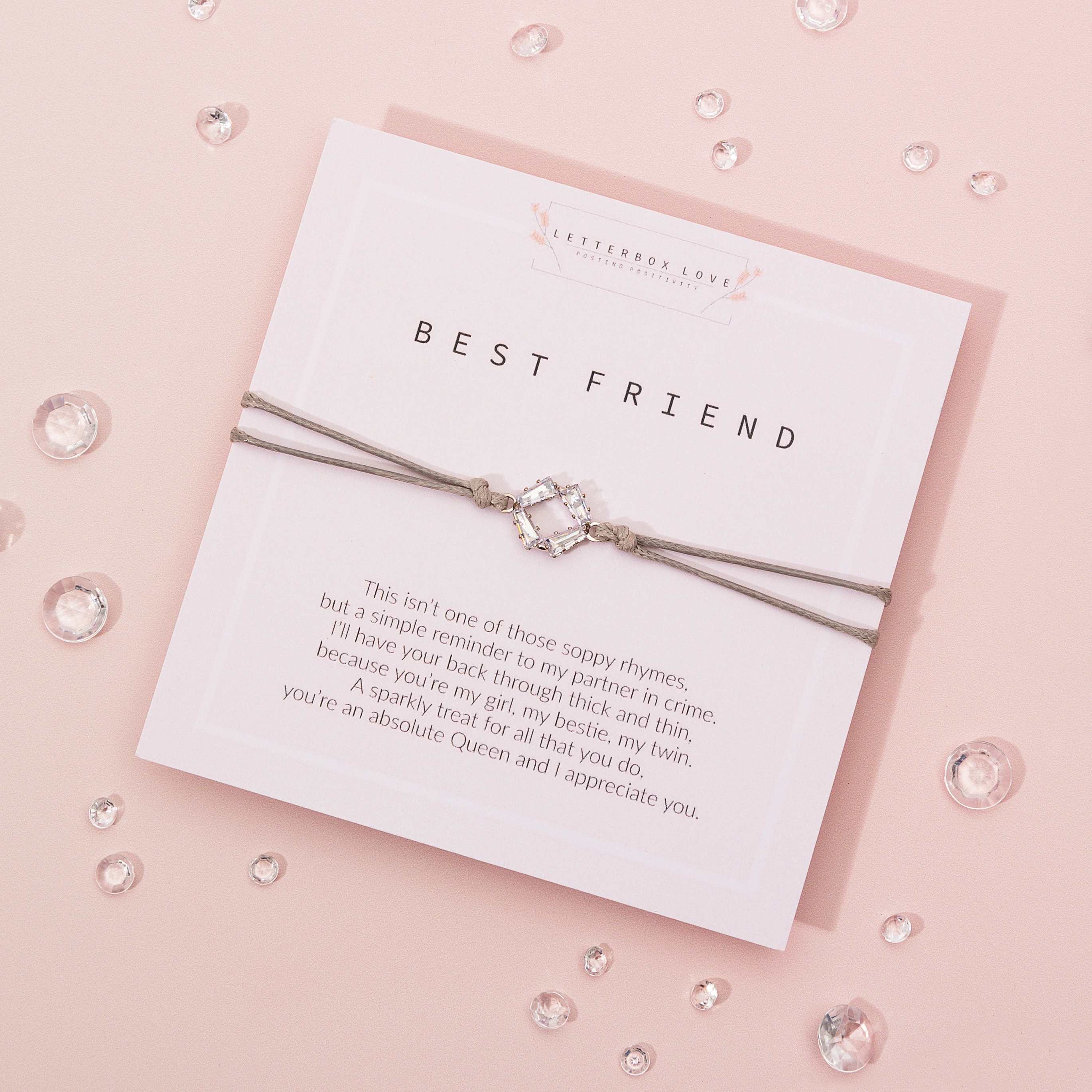 A stylish Best Friend Wish Bracelet featuring cubic zirconias on a polyester thread, presented in an elegant ivory envelope.