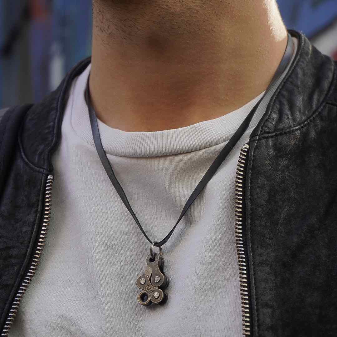 Bikeman Recycled Bike Chain Pendant Necklace showcasing a unique bike chain link design, eco-friendly materials, and adjustable inner tube cord.