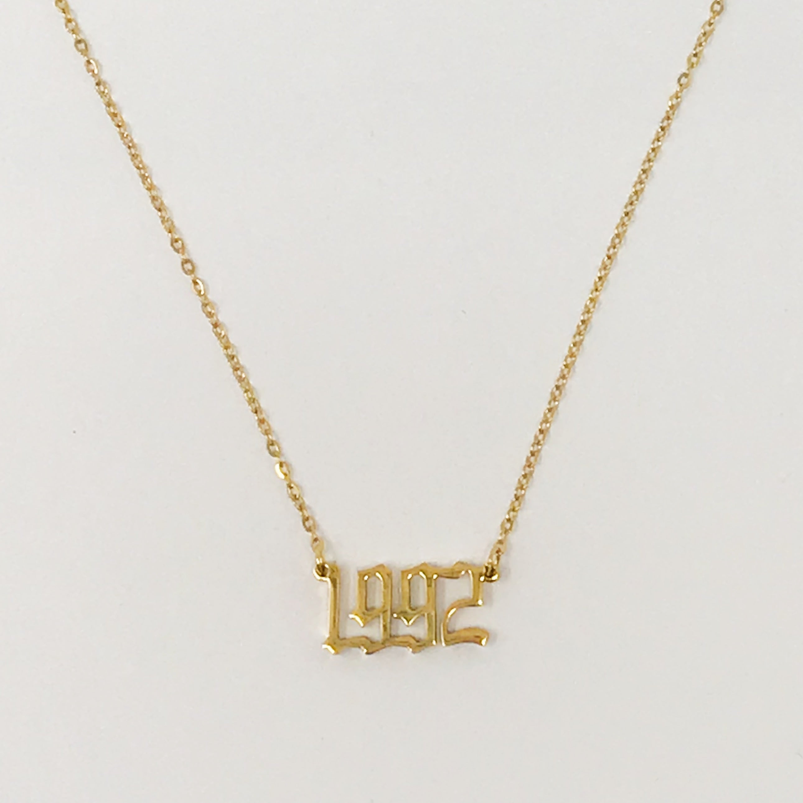 Birth Year Necklace featuring old English font, 16-inch chain with extender, and 18K gold plated stainless steel.