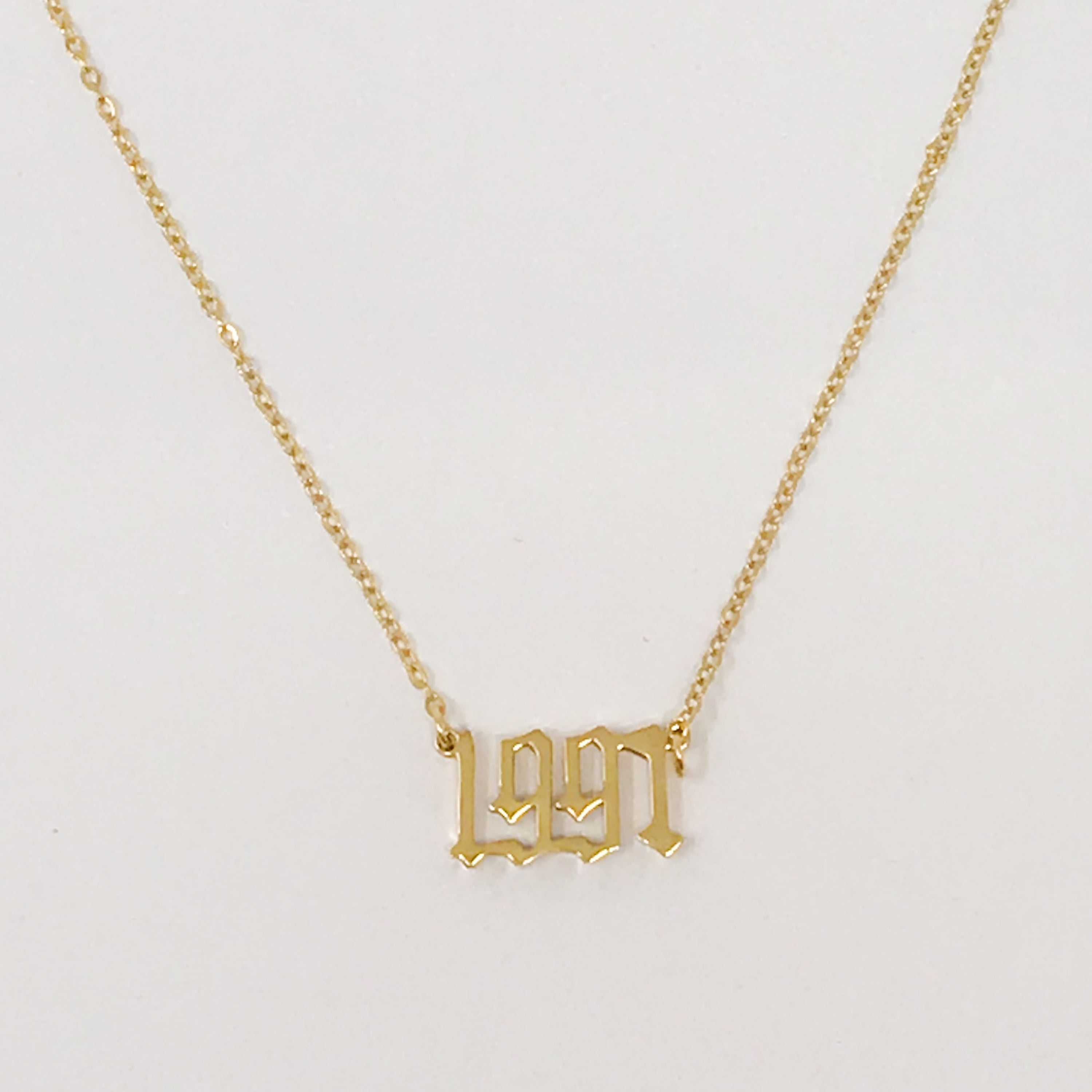 Birth Year Necklace featuring old English font, 16-inch chain with extender, and 18K gold plated stainless steel.