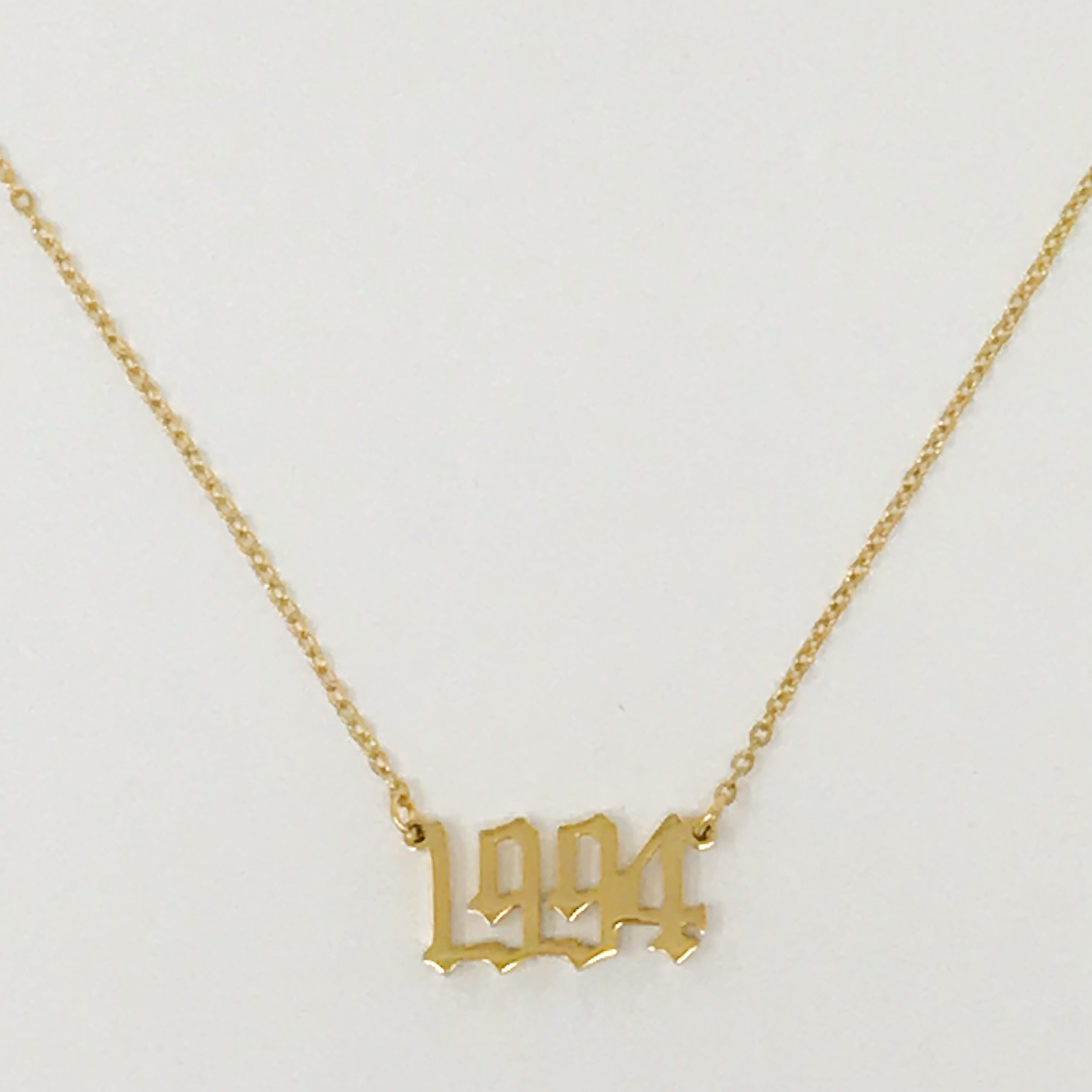 Birth Year Necklace featuring old English font, 16-inch chain with extender, and 18K gold plated stainless steel.