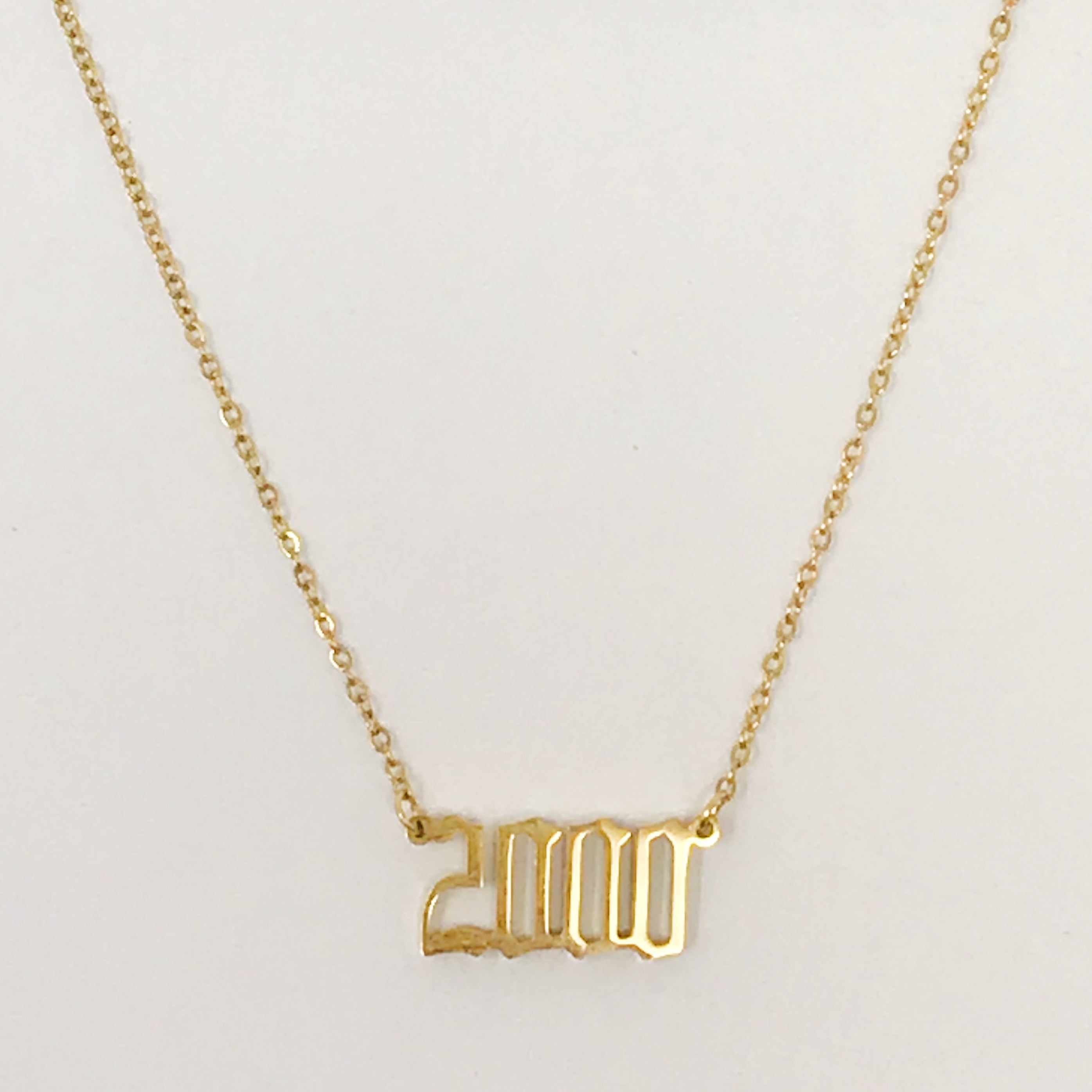 Birth Year Necklace featuring old English font, 16-inch chain with extender, and 18K gold plated stainless steel.