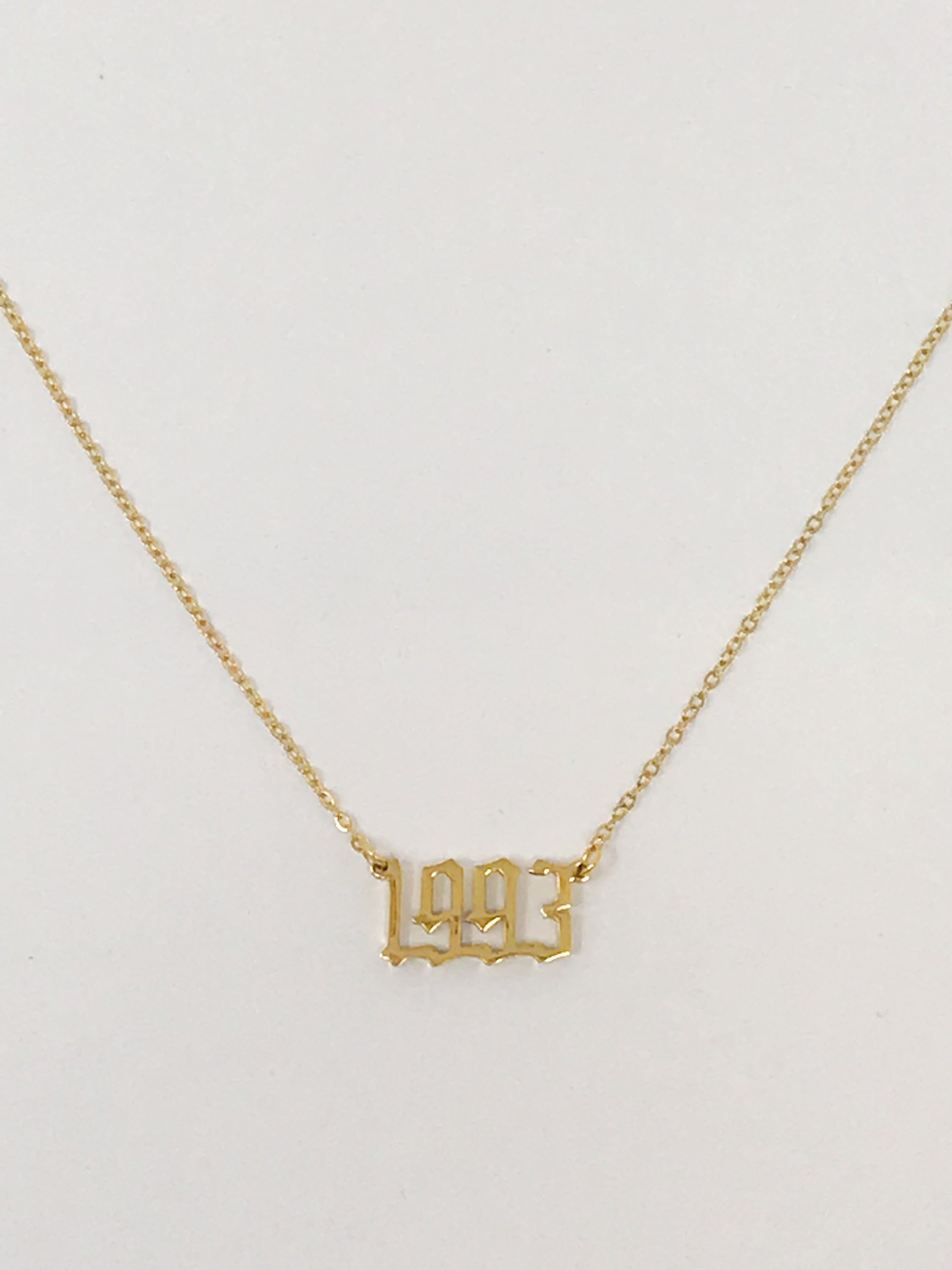 Birth Year Necklace featuring old English font, 16-inch chain with extender, and 18K gold plated stainless steel.