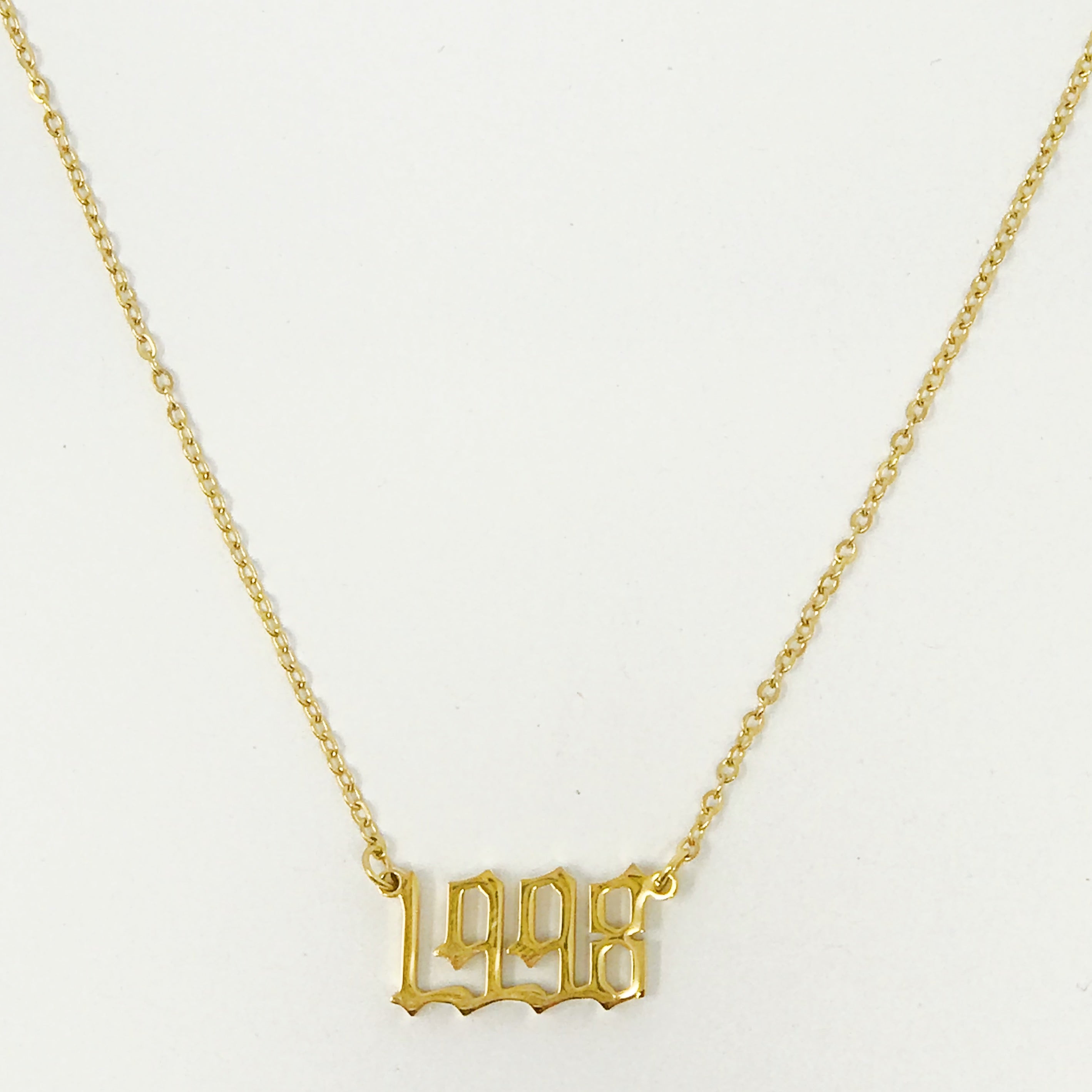 Birth Year Necklace featuring old English font, 16-inch chain with extender, and 18K gold plated stainless steel.