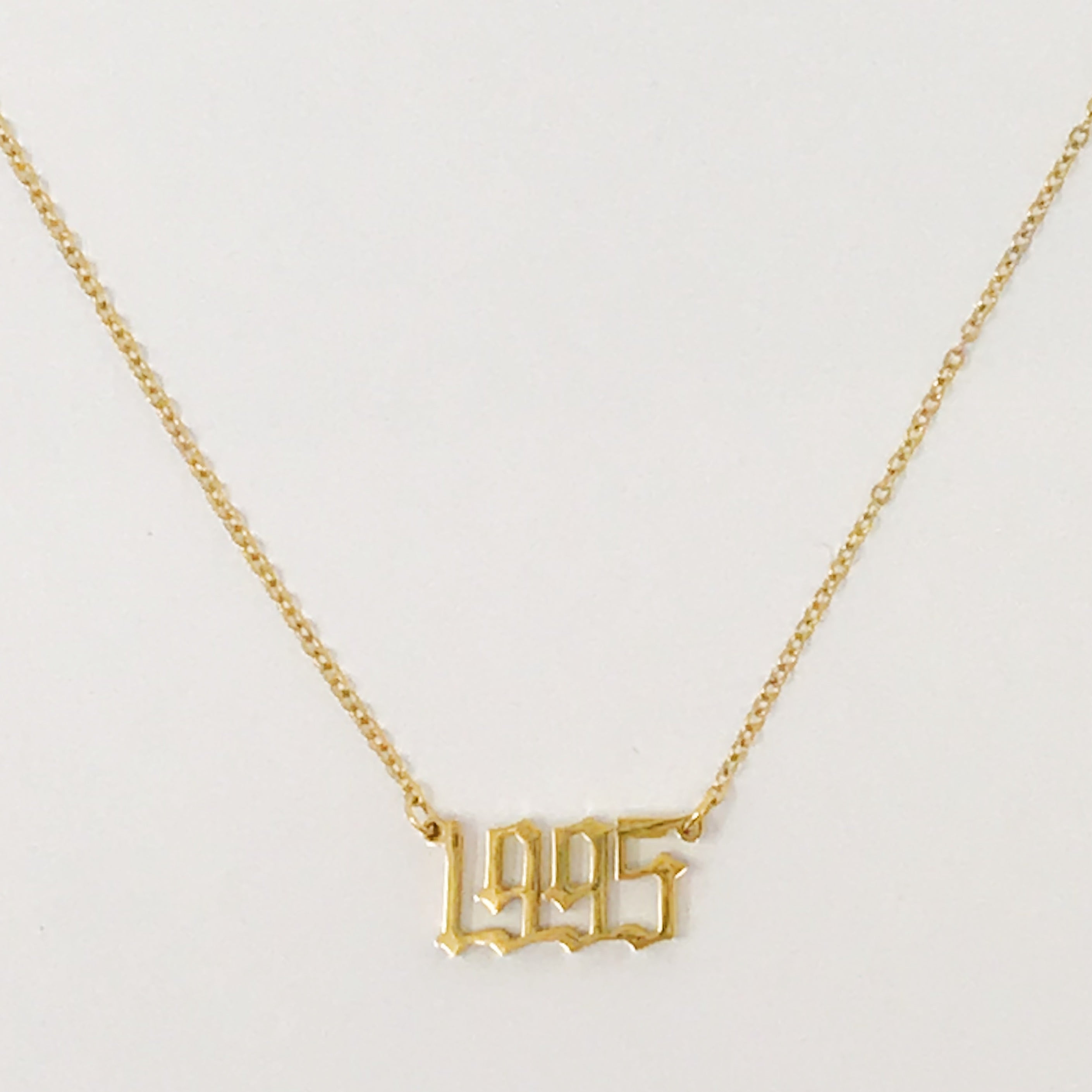 Birth Year Necklace featuring old English font, 16-inch chain with extender, and 18K gold plated stainless steel.