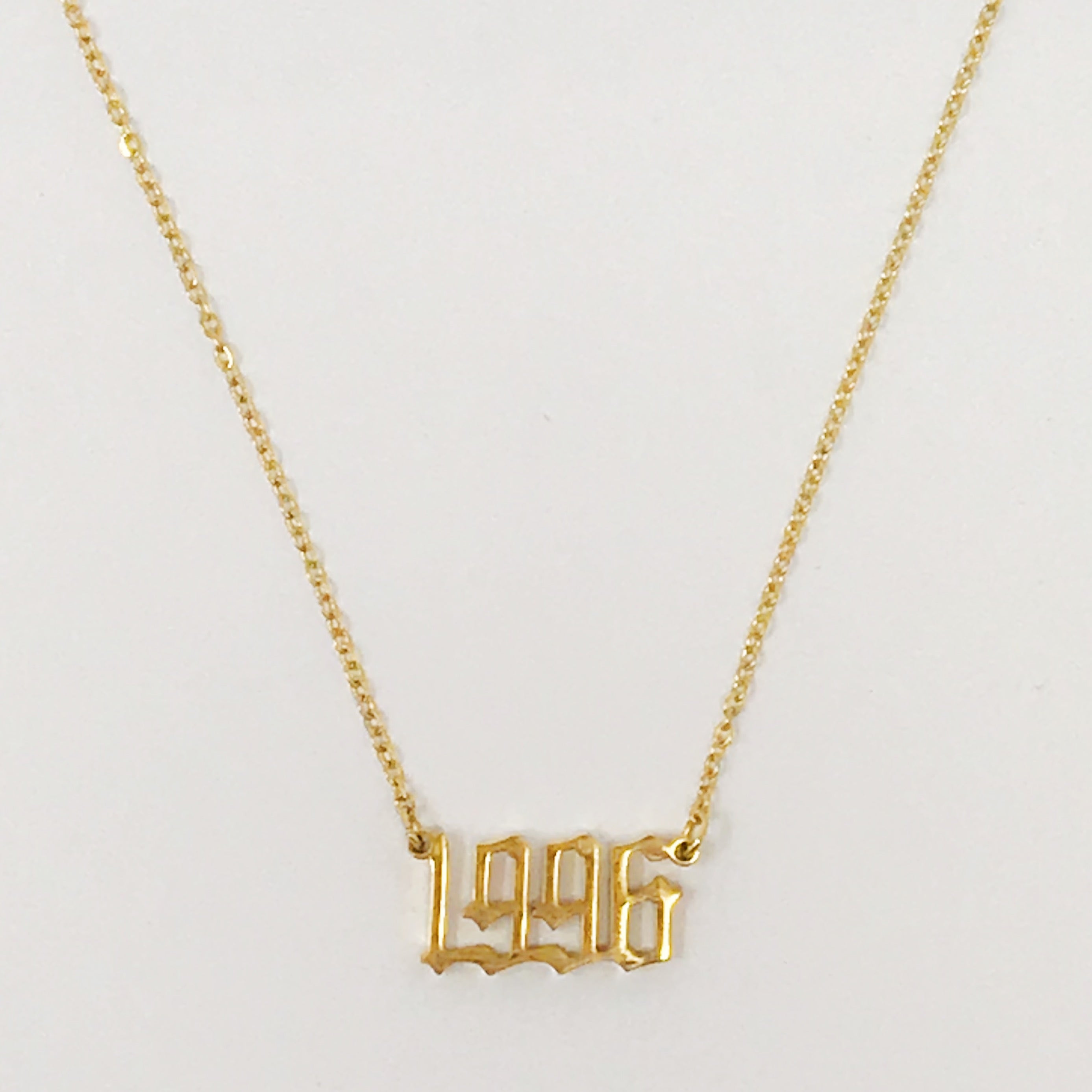 Birth Year Necklace featuring old English font, 16-inch chain with extender, and 18K gold plated stainless steel.