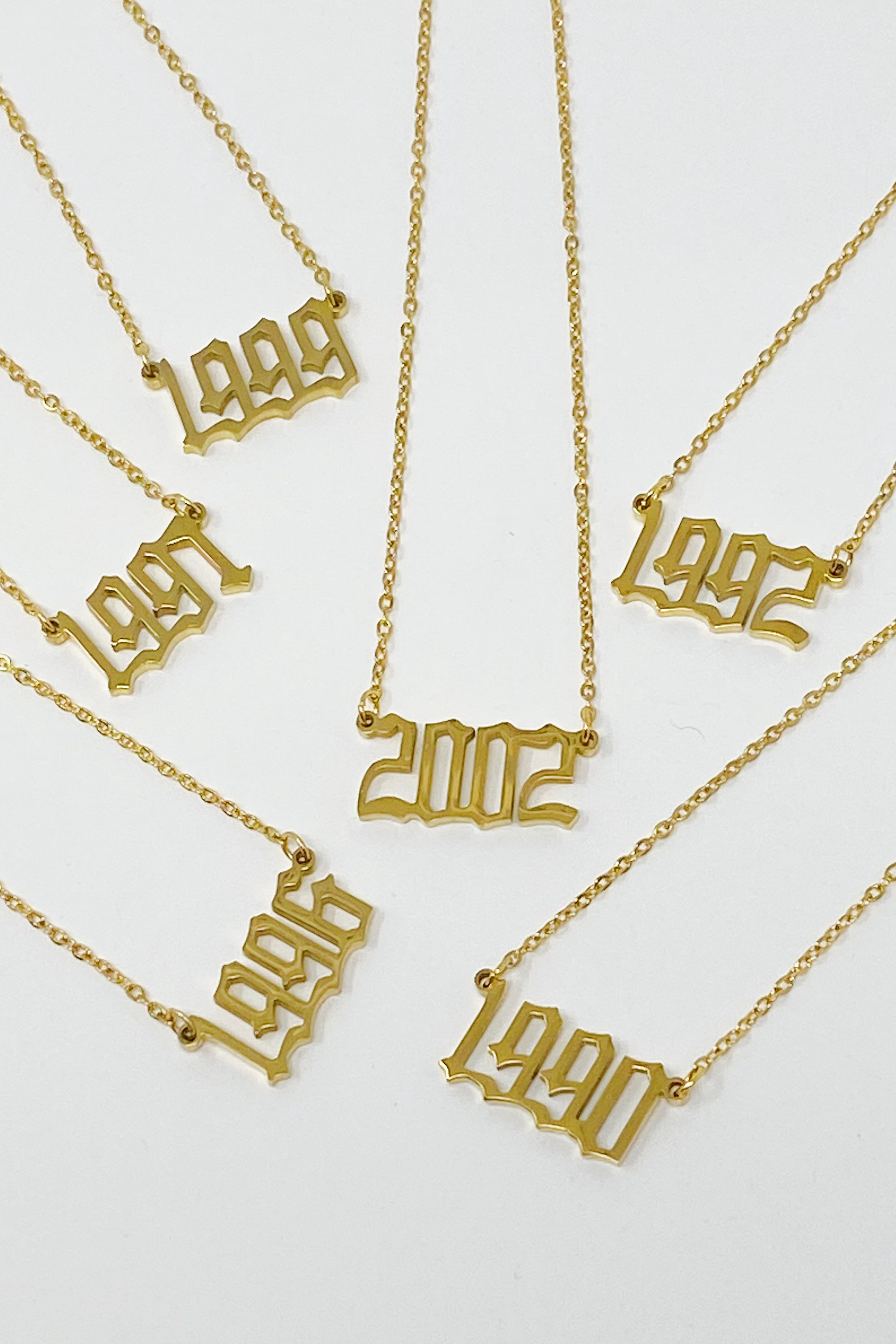 Birth Year Necklace featuring old English font, 16-inch chain with extender, and 18K gold plated stainless steel.