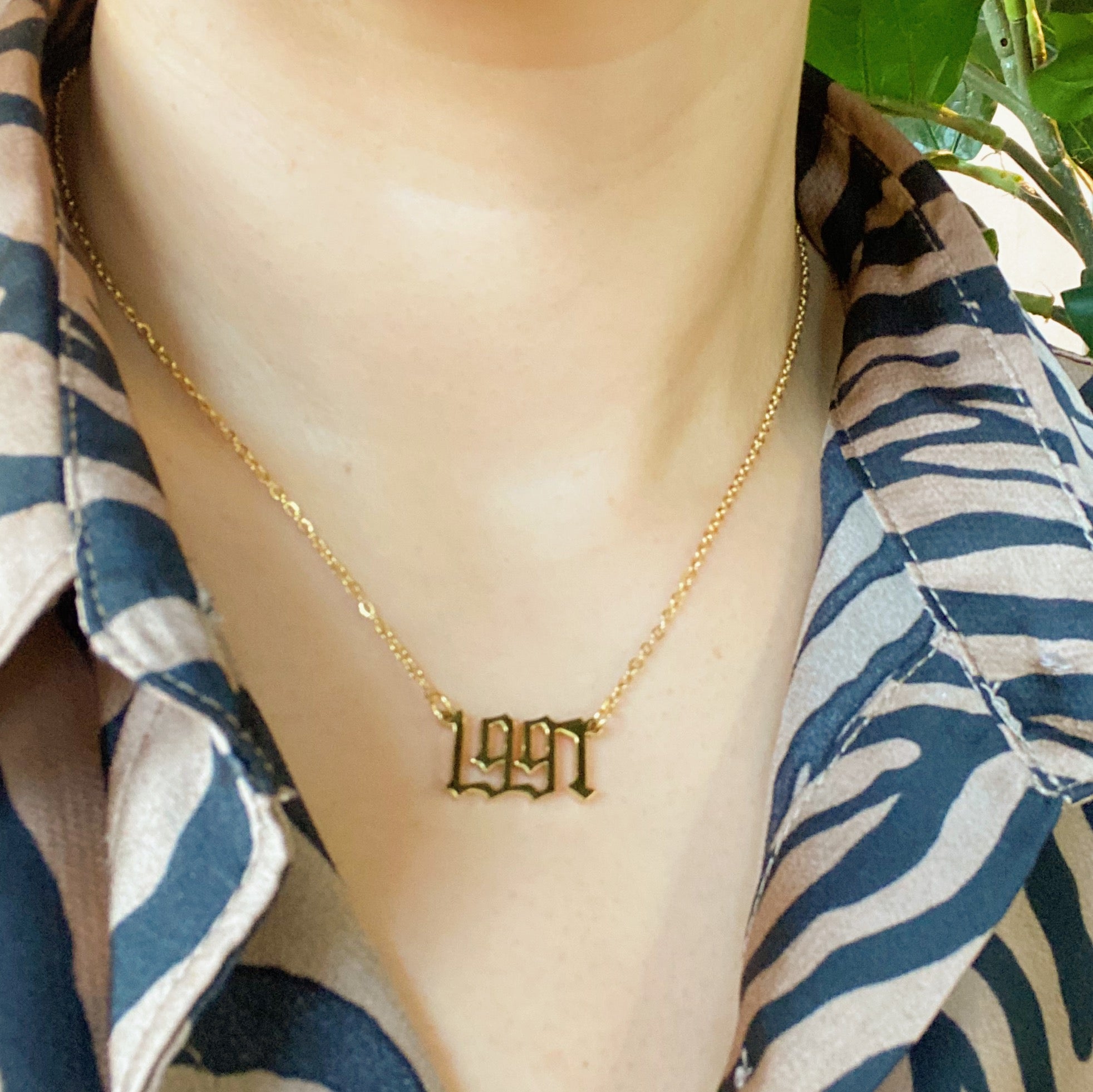 Birth Year Necklace featuring old English font, 16-inch chain with extender, and 18K gold plated stainless steel.