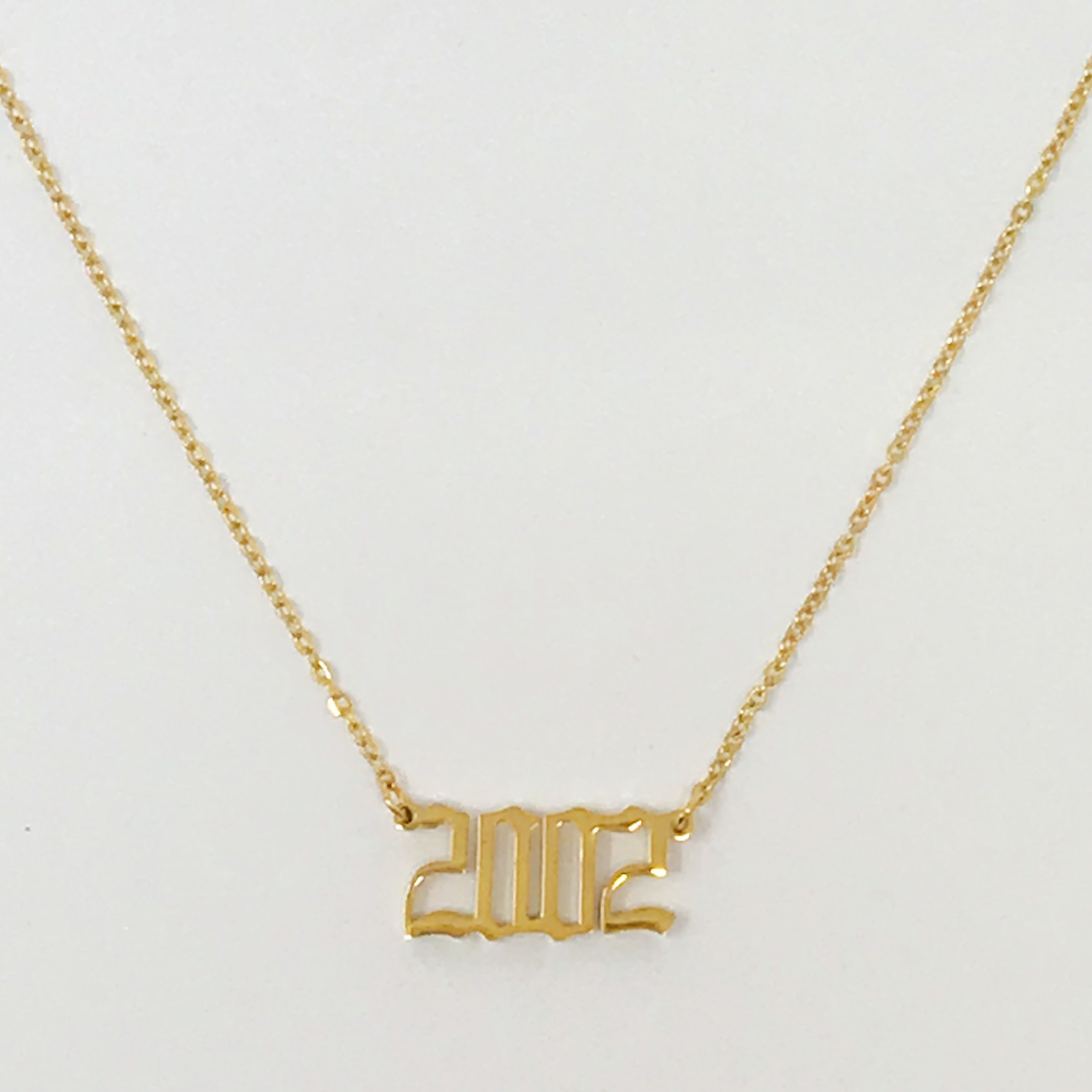 Birth Year Necklace featuring old English font, 16-inch chain with extender, and 18K gold plated stainless steel.