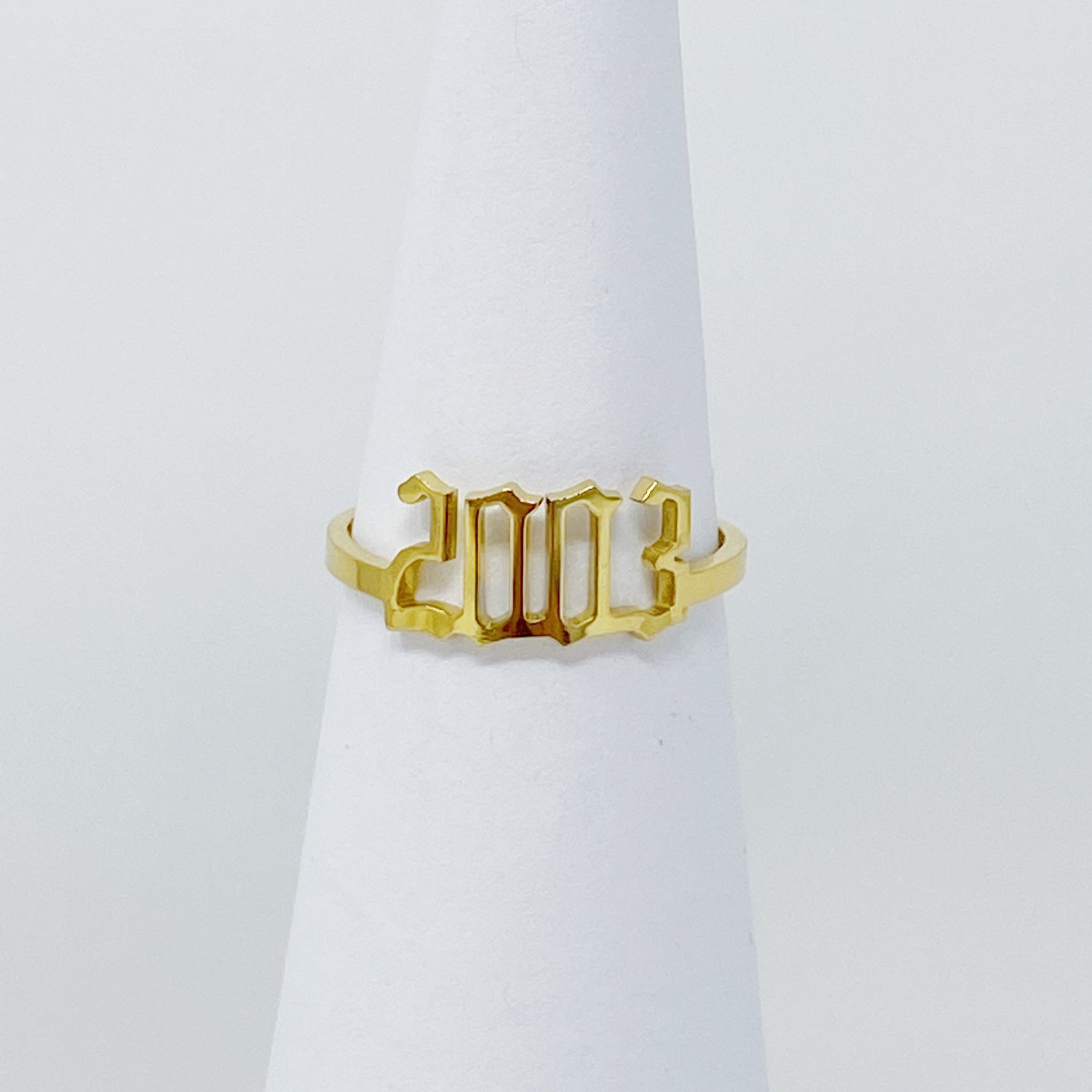 A stylish Birth Year Ring featuring the years 1993 to 2003 in an elegant old English font, crafted from stainless steel and gold plated.