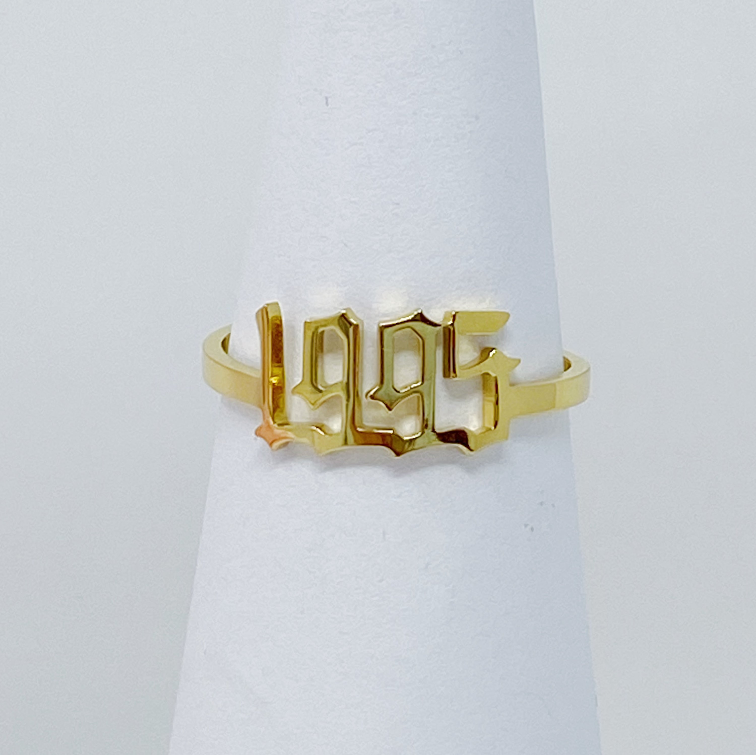 A stylish Birth Year Ring featuring the years 1993 to 2003 in an elegant old English font, crafted from stainless steel and gold plated.