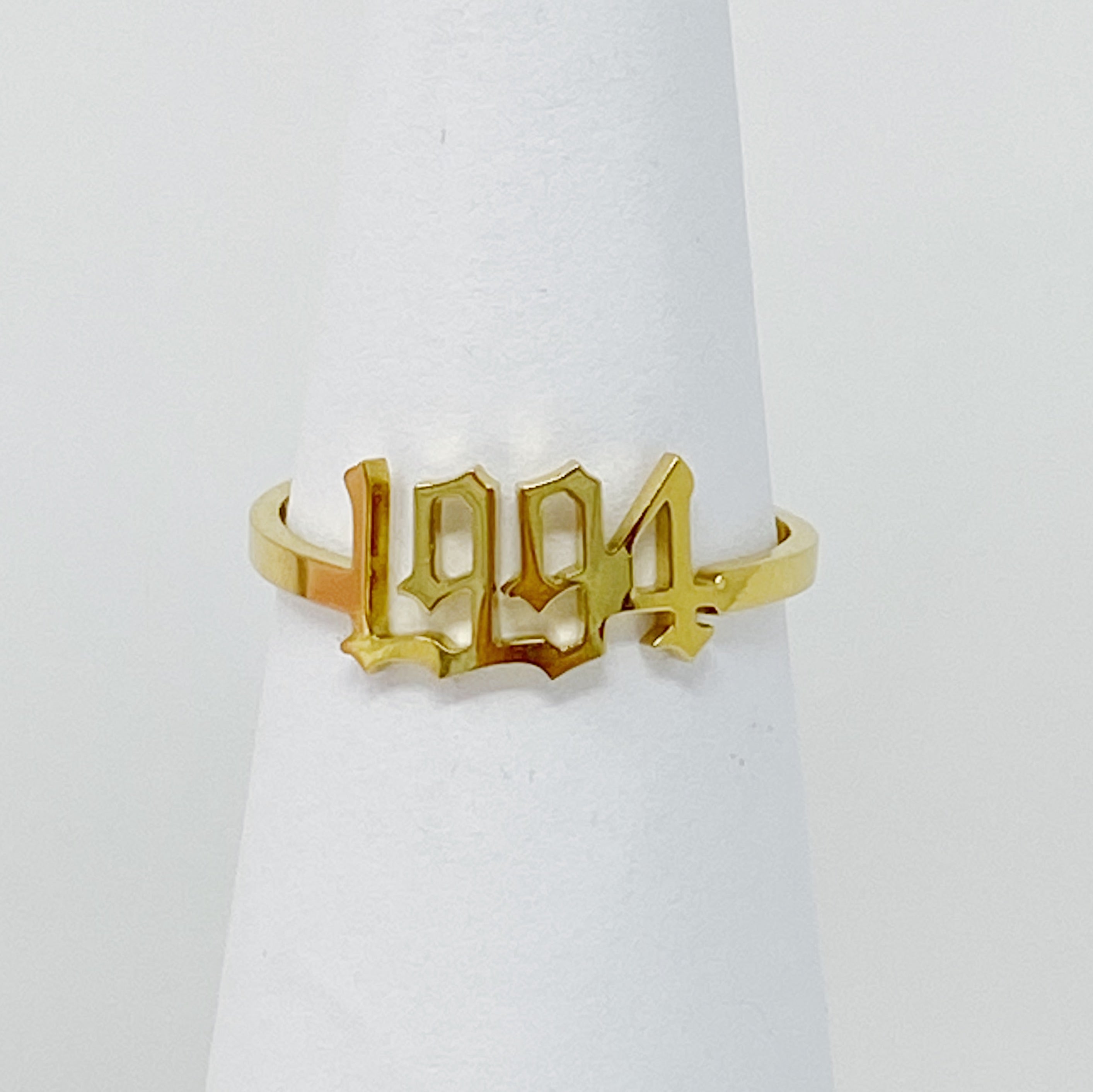 A stylish Birth Year Ring featuring the years 1993 to 2003 in an elegant old English font, crafted from stainless steel and gold plated.