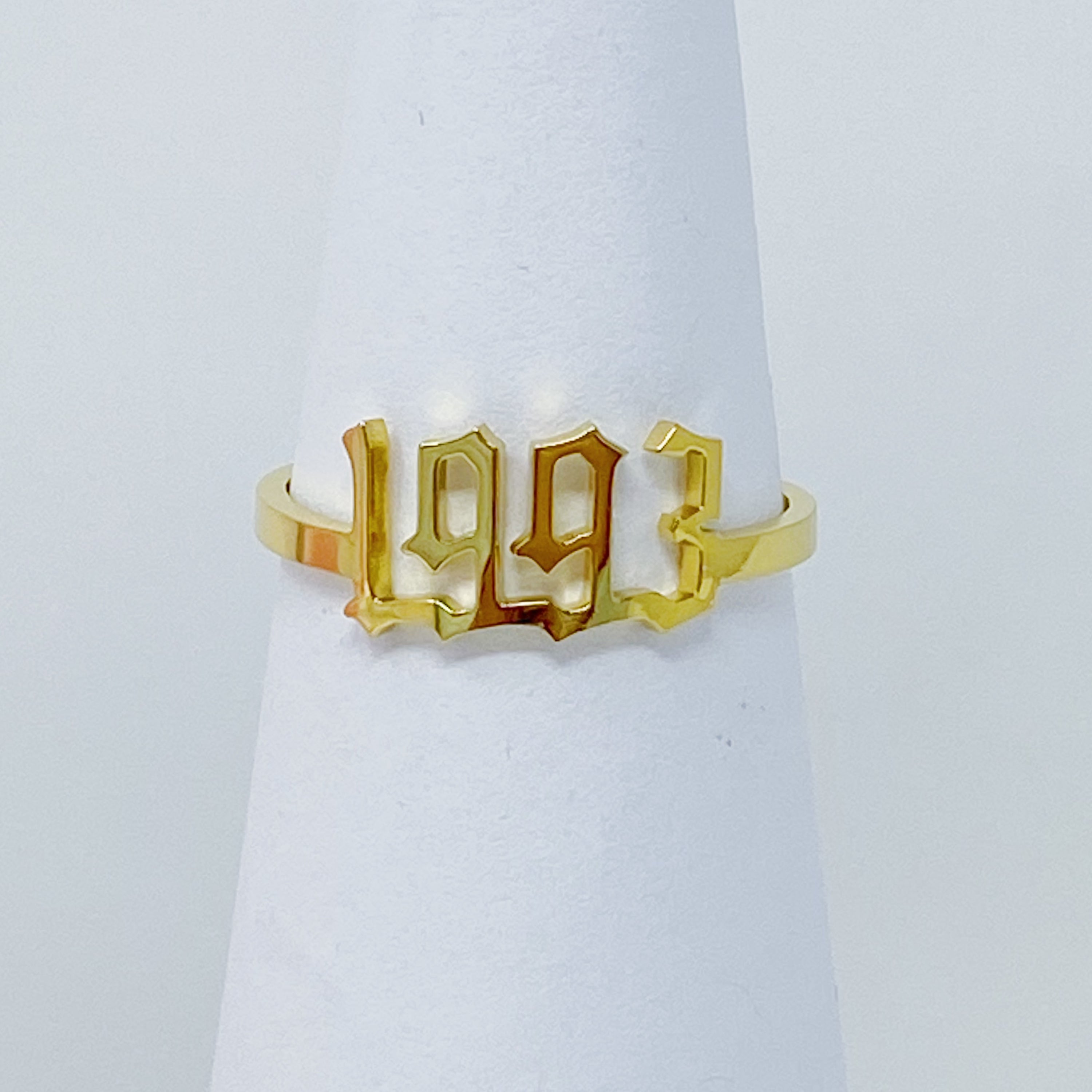 A stylish Birth Year Ring featuring the years 1993 to 2003 in an elegant old English font, crafted from stainless steel and gold plated.