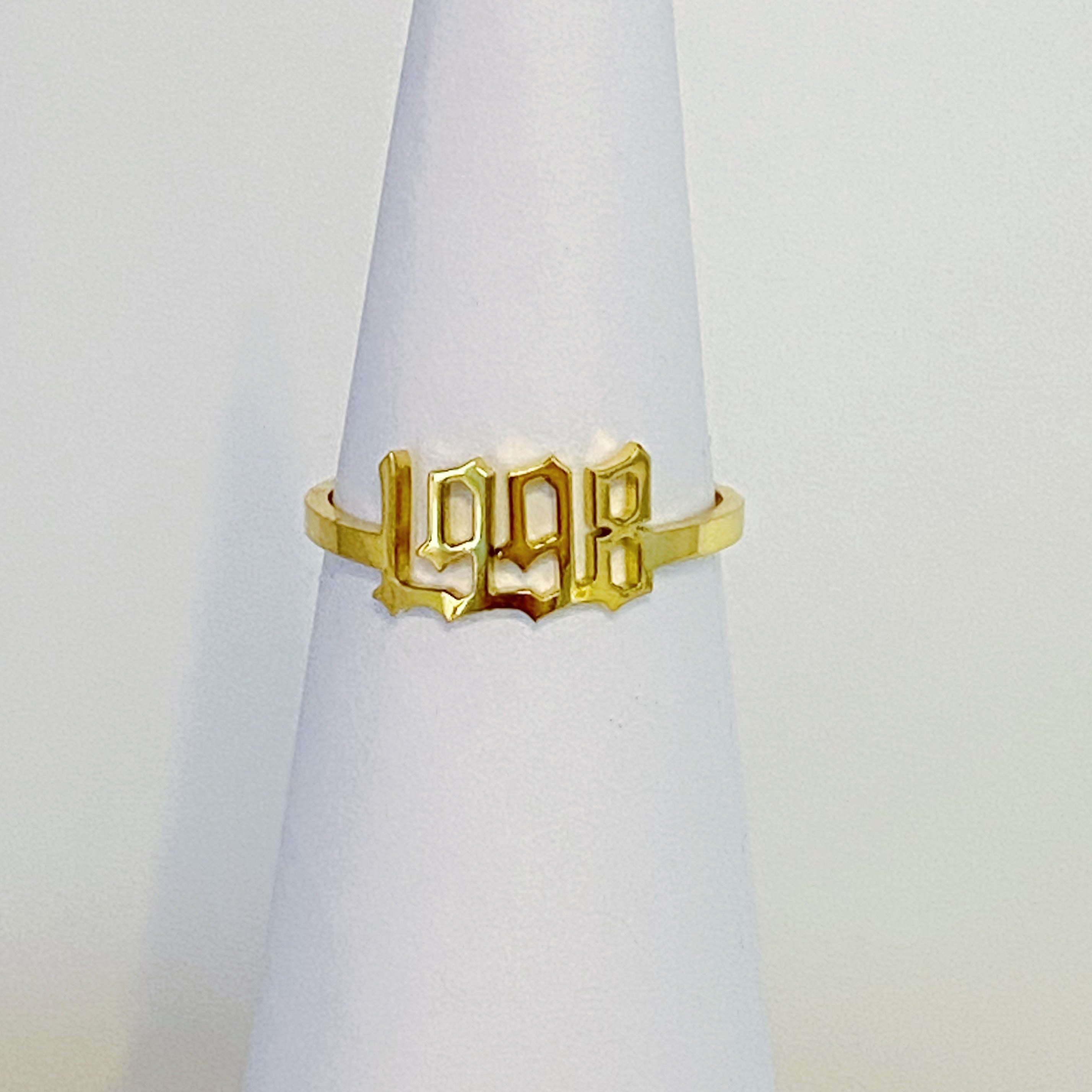 A stylish Birth Year Ring featuring the years 1993 to 2003 in an elegant old English font, crafted from stainless steel and gold plated.