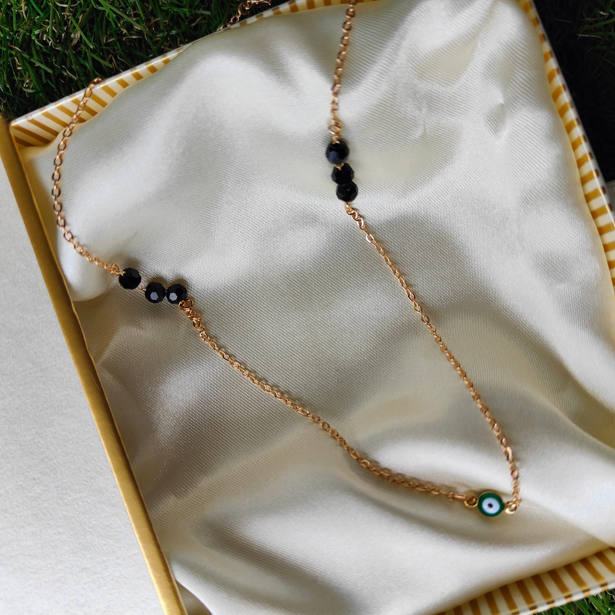 Elegant Evil Eye Black Bead Mangalsutra Necklace featuring silver and gold plating with black beads and a protective charm.