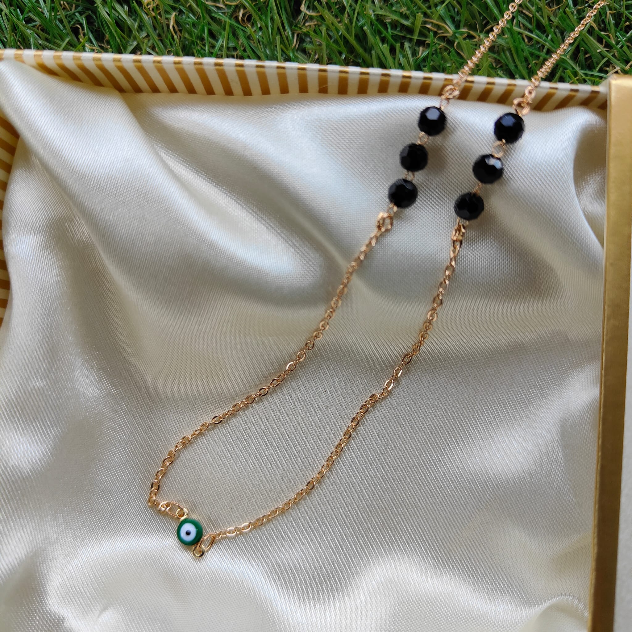 Elegant Evil Eye Black Bead Mangalsutra Necklace featuring silver and gold plating with black beads and a protective charm.