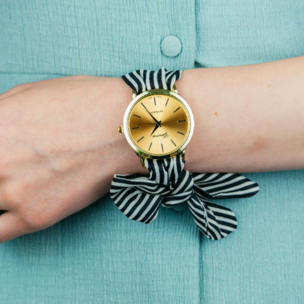 Black Changeable Stripe Cloth Women Bracelet Wristwatch with a stylish cotton strap and metal dial, showcasing its unique tie closure.