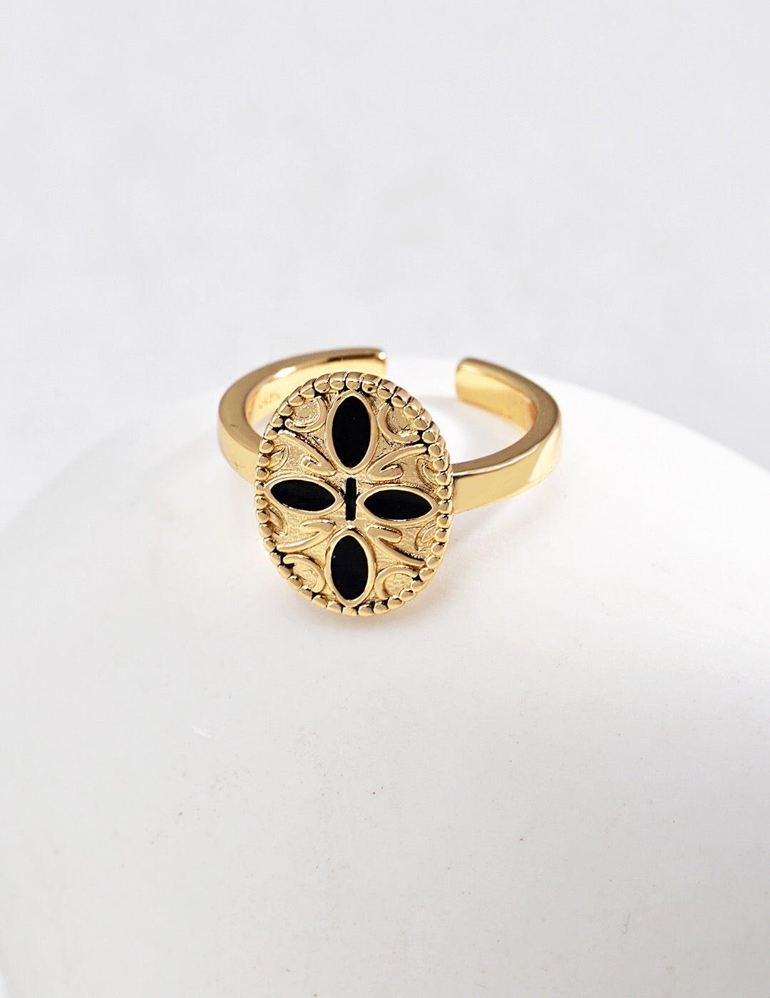 Black Cross Print Drop Glaze Ring featuring a unique drip glaze finish and gold vermeil plating, elegantly displayed in a jewelry pouch.