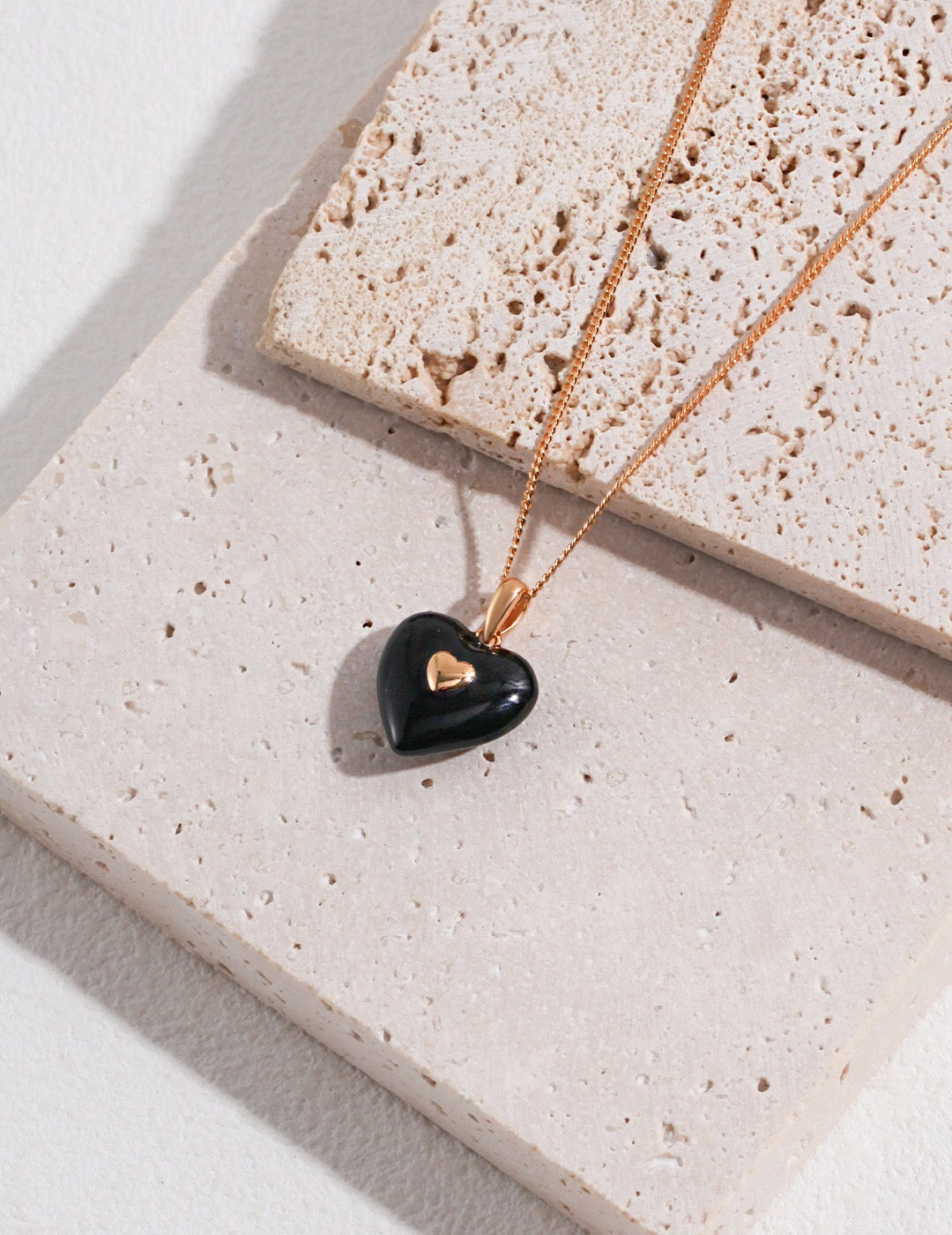 Elegant Black Drip Glaze Heart Pendant Necklace with gold vermeil chain, showcasing a unique artistic design.