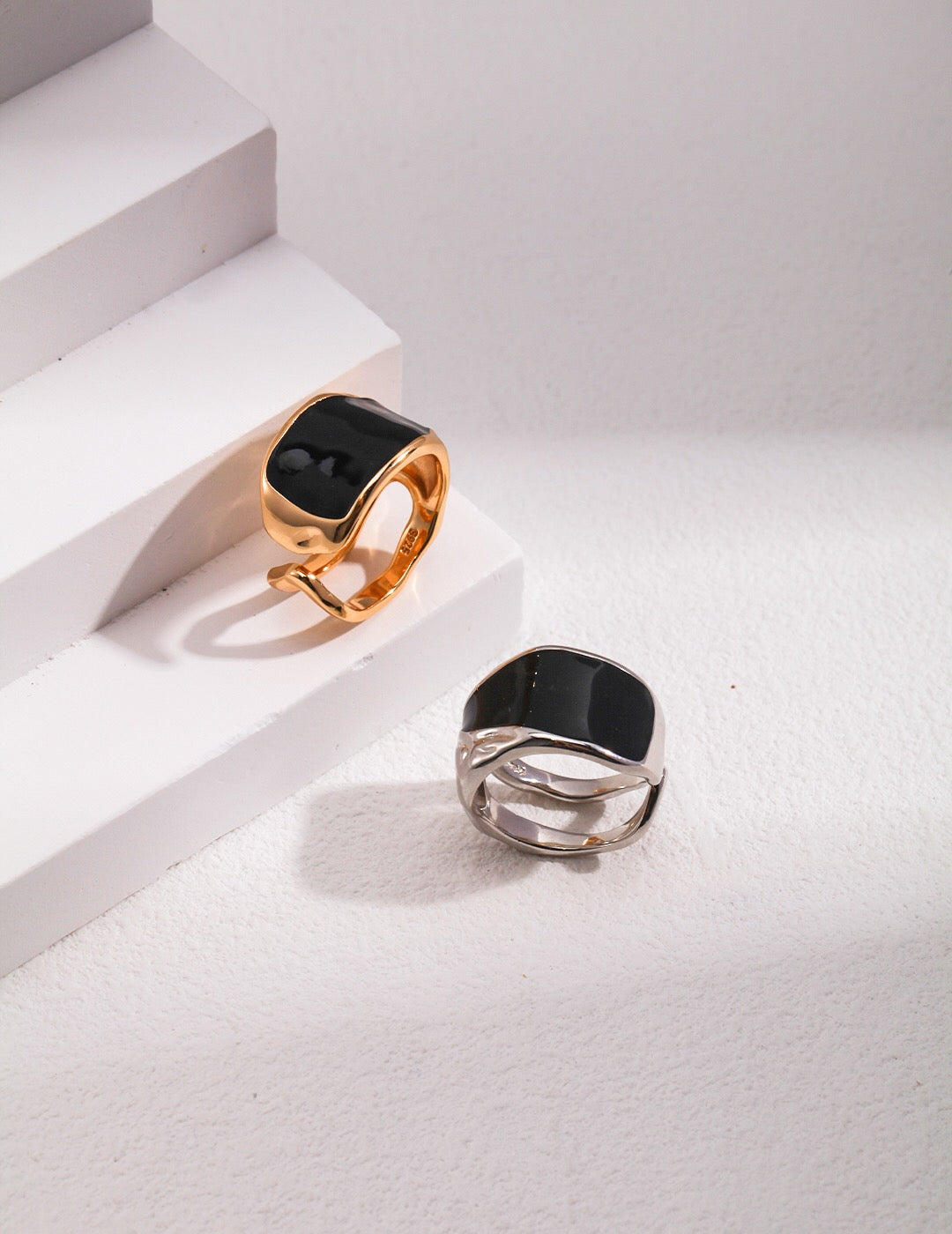 A stunning black enamel ring with gold vermeil plating, showcasing its elegant design and craftsmanship.