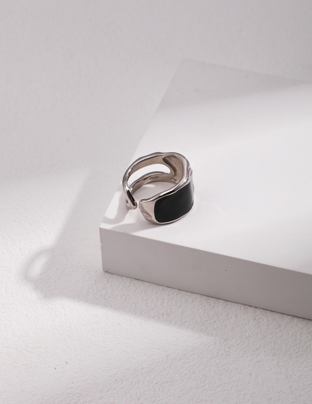 A stunning black enamel ring with gold vermeil plating, showcasing its elegant design and craftsmanship.