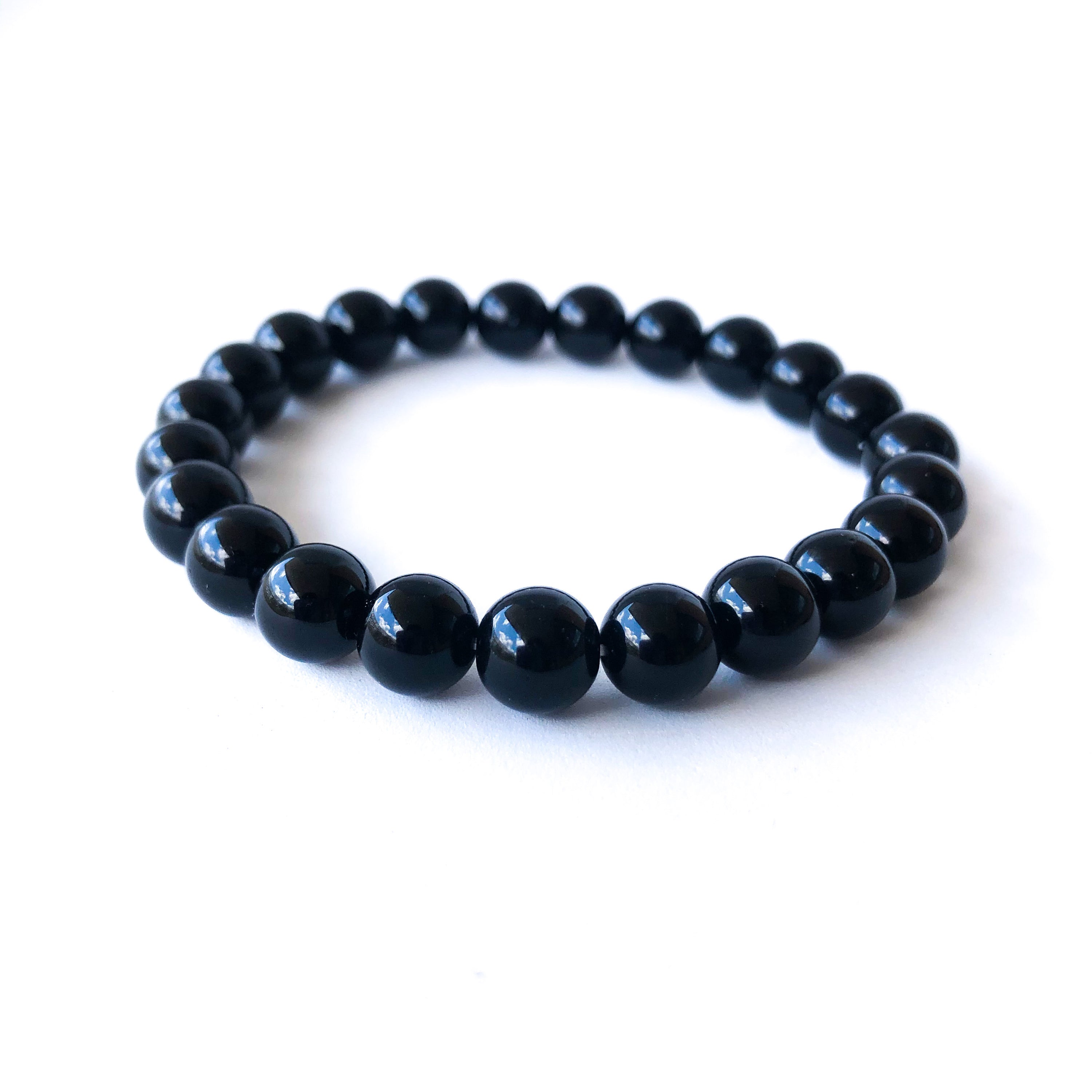 Black Lives Matter Bracelet Set featuring a silicone bracelet and a handcrafted Black Onyx beaded bracelet, symbolizing strength and remembrance.