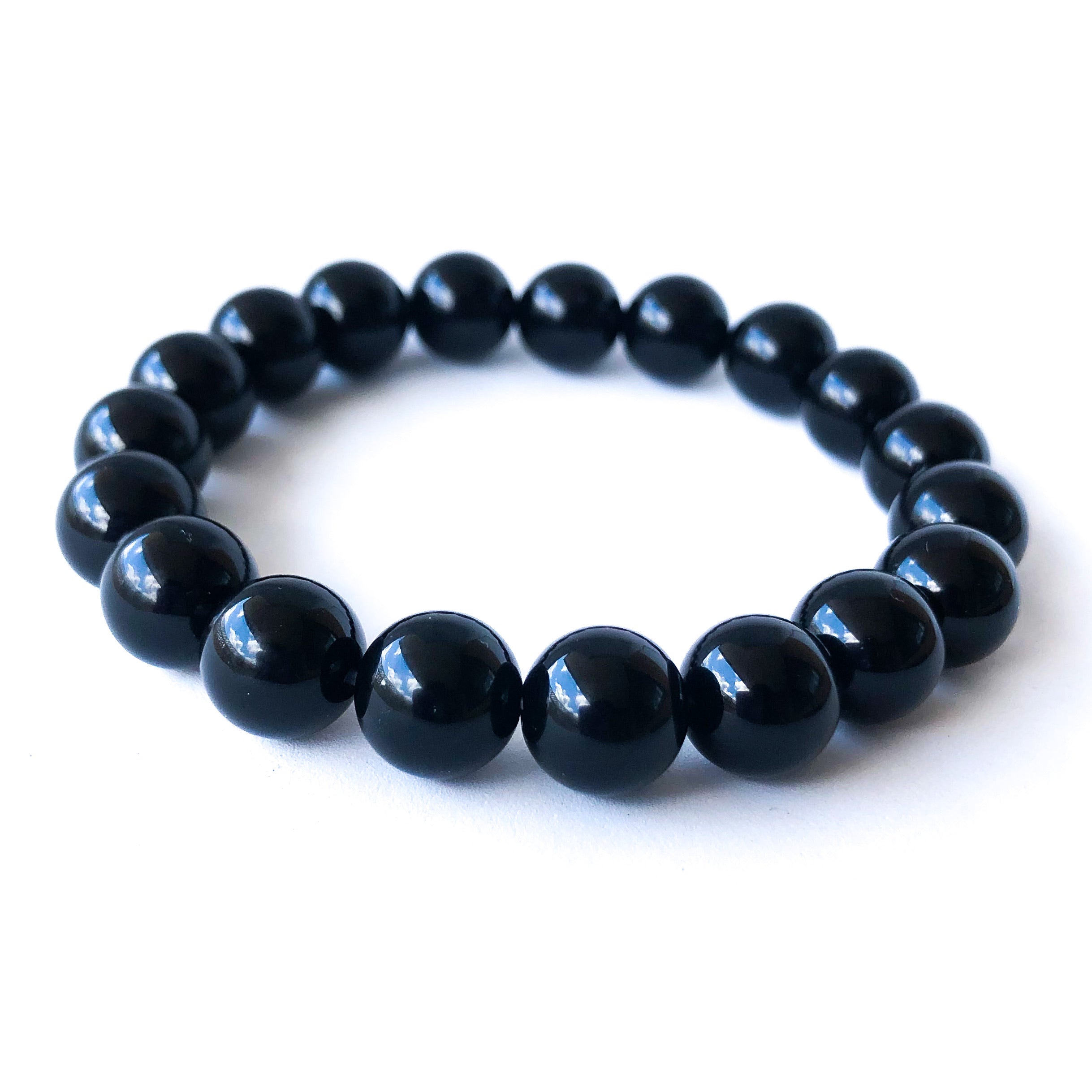 Black Lives Matter Bracelet Set featuring a silicone bracelet and a handcrafted Black Onyx beaded bracelet, symbolizing strength and remembrance.