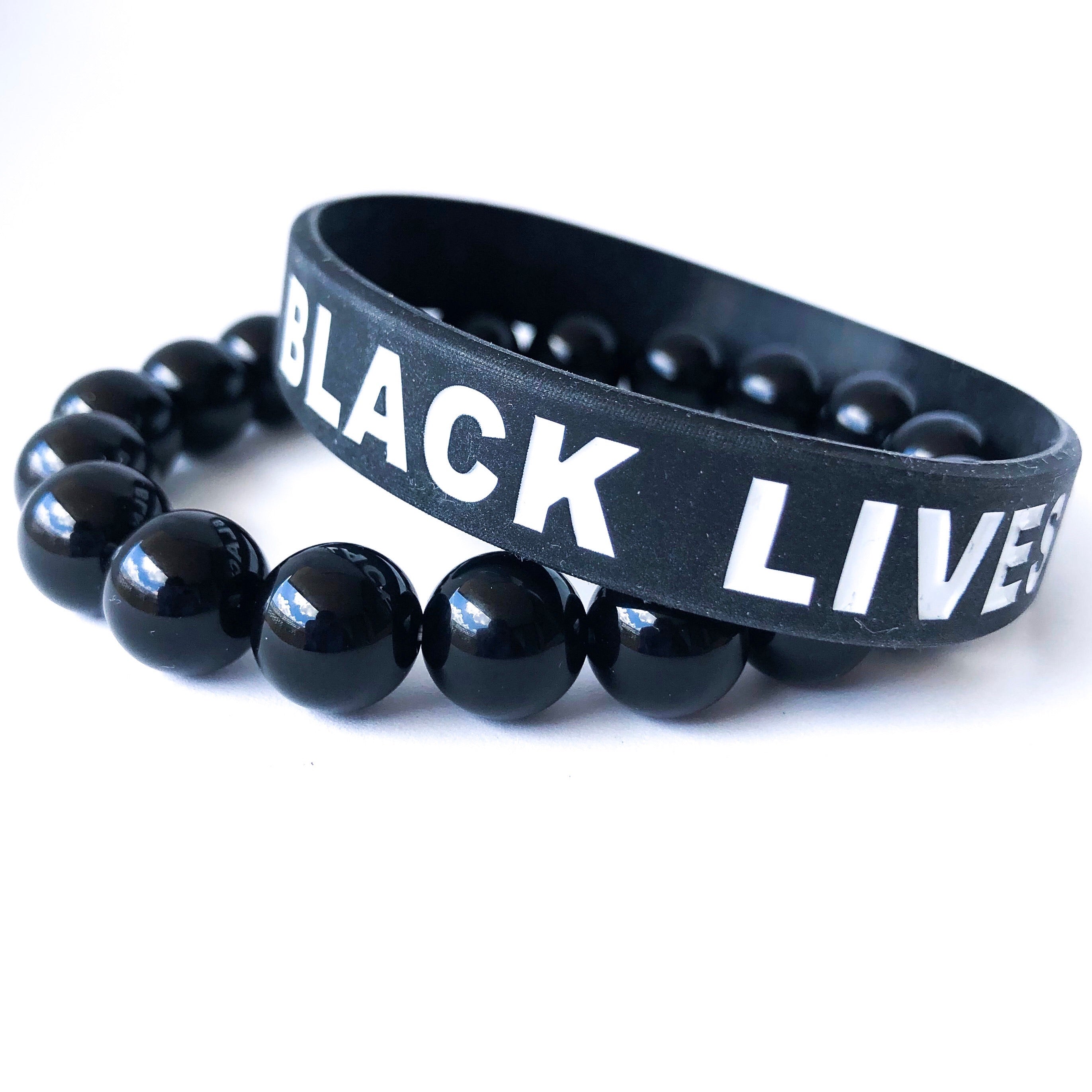 Black Lives Matter Bracelet Set featuring a silicone bracelet and a handcrafted Black Onyx beaded bracelet, symbolizing strength and remembrance.