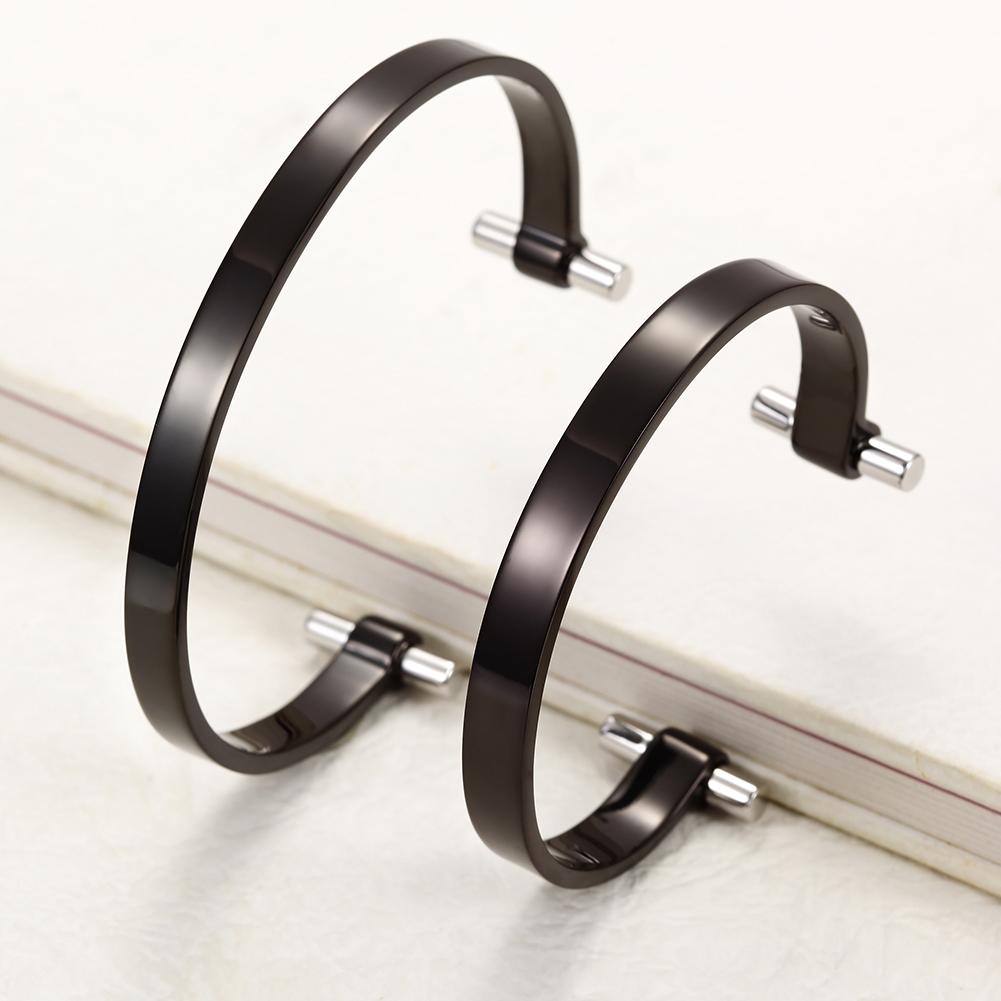 Black Love Couple Cuff made of surgical stainless steel with gold plating, showcasing a sleek and modern design.