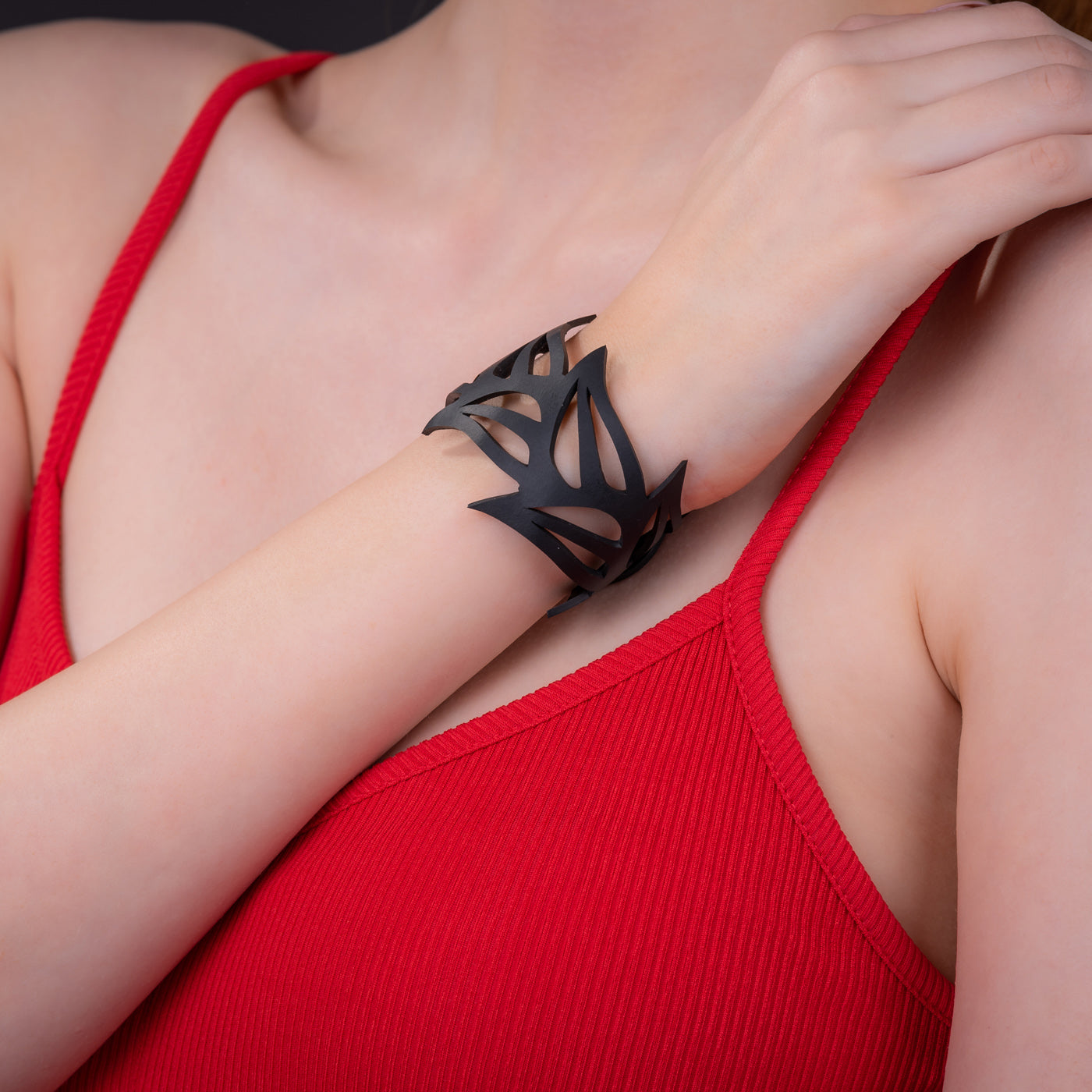 Black Tulip Rubber Bracelet made from reclaimed tyre inner tubes, featuring a floral design and a plastic button clasp.