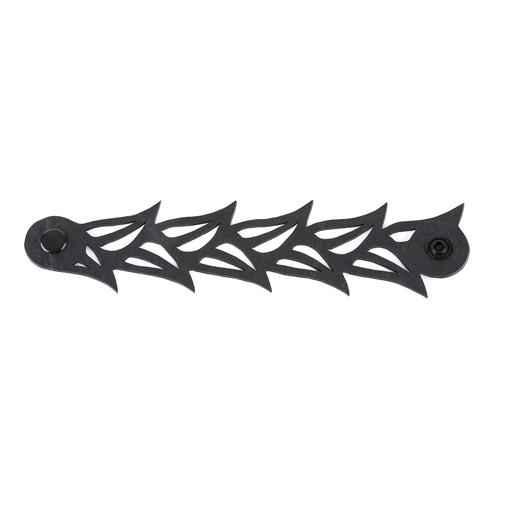 Black Tulip Rubber Bracelet made from reclaimed tyre inner tubes, featuring a floral design and a plastic button clasp.