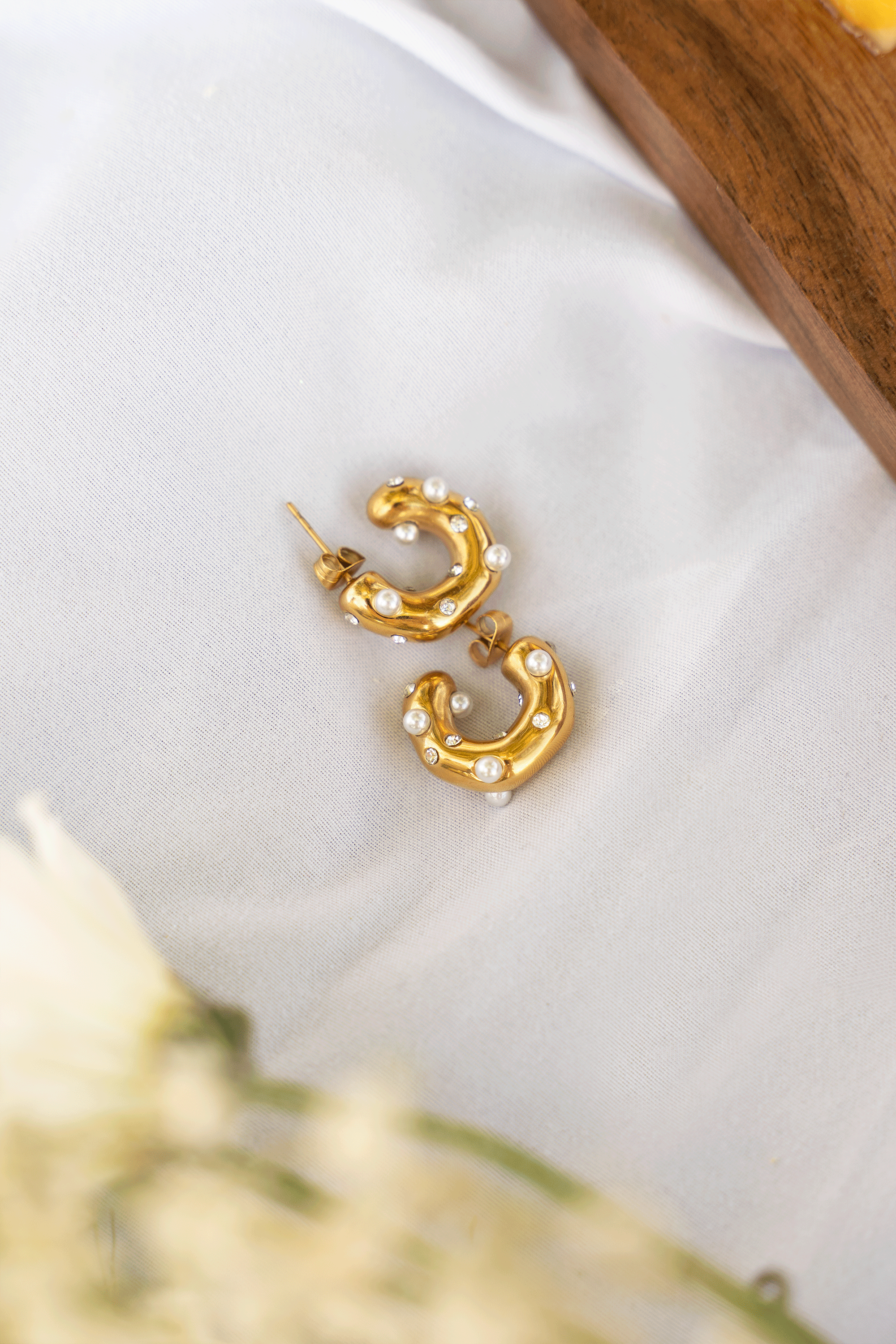 BLAIRE Hoops featuring yellow gold plating and white freshwater pearls, elegantly designed in a c-shaped hoop style.