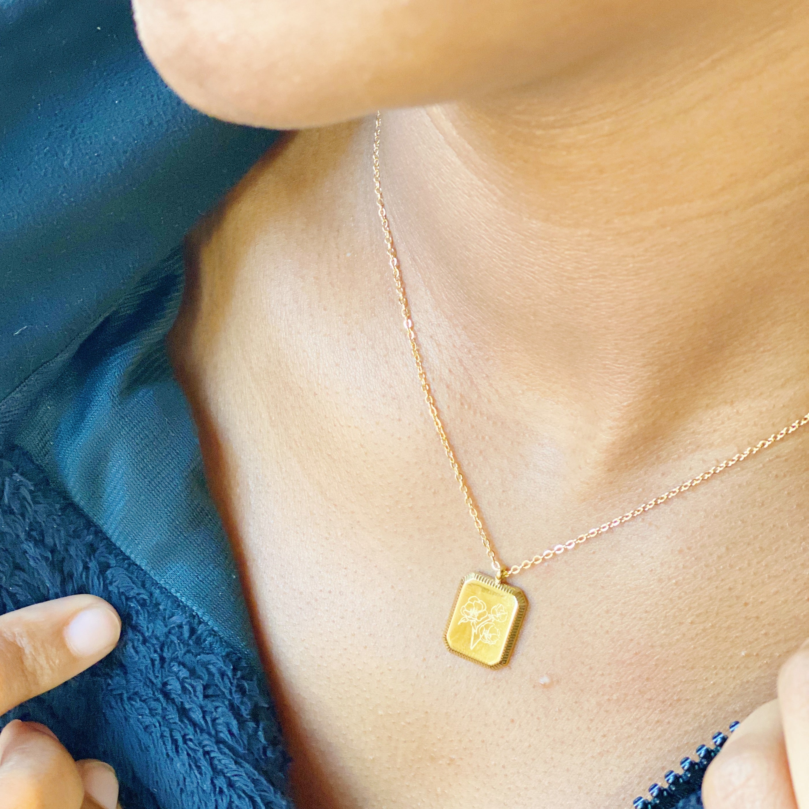 Blooming Birth Month Necklace featuring engraved flowers for each month, gold plated stainless steel with a square pendant and detailed edge finish.