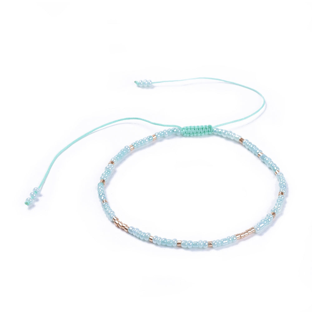 A beautiful blue beaded friendship bracelet with delicate glass seed beads and an adjustable cord, perfect for gifting or personal wear.