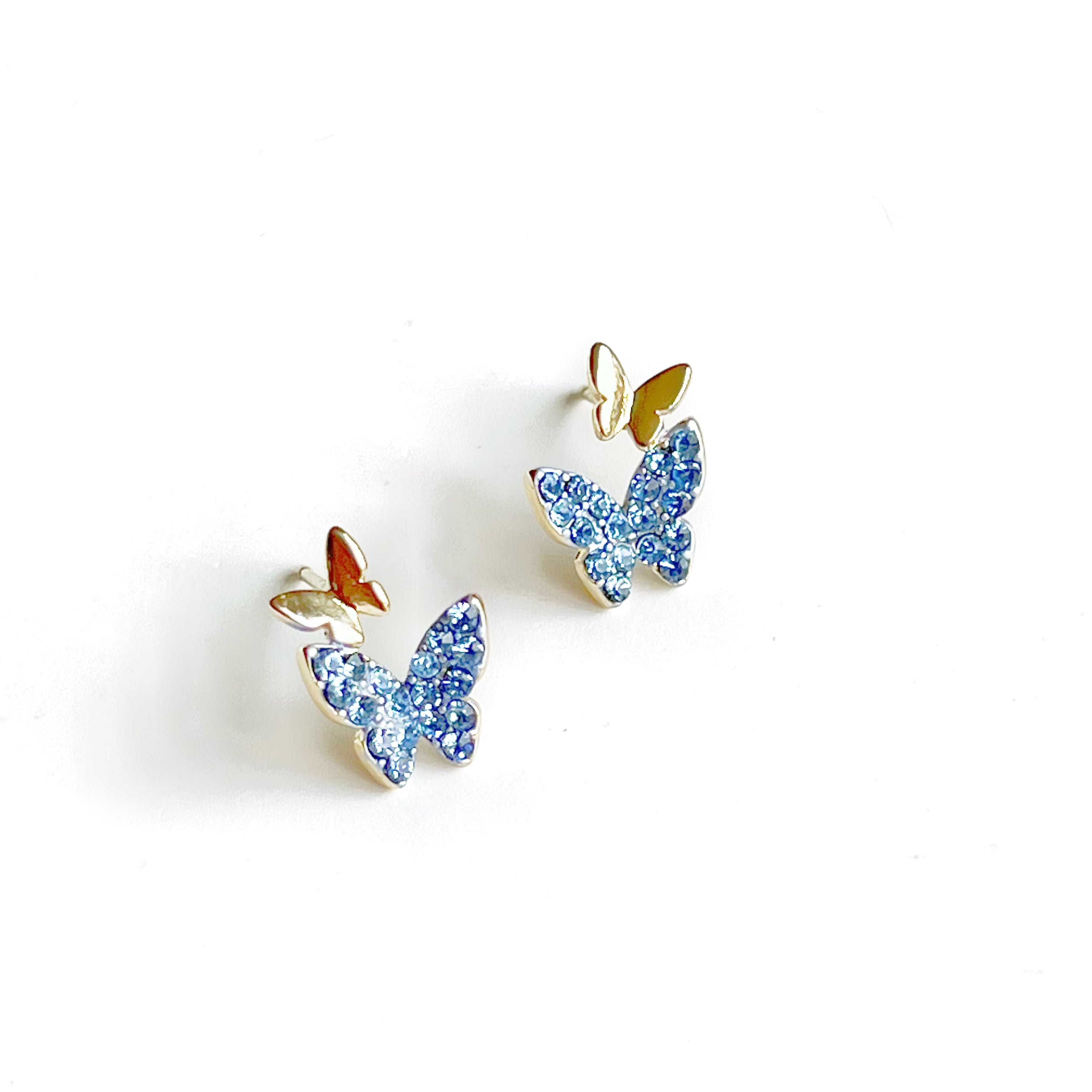 A pair of elegant blue crystal butterfly earrings made from gold-plated sterling silver and bronze, featuring shimmering blue zircon stones.