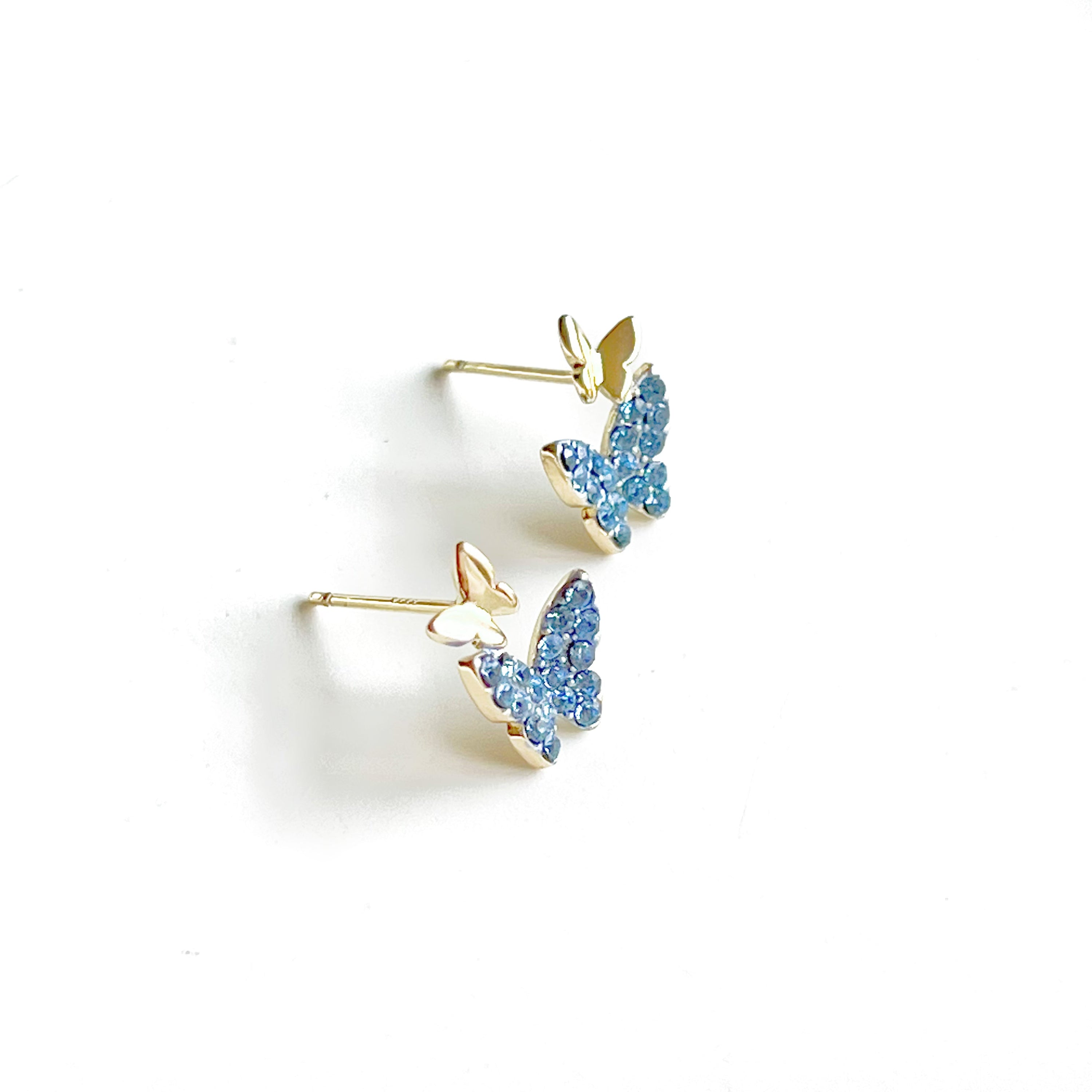 A pair of elegant blue crystal butterfly earrings made from gold-plated sterling silver and bronze, featuring shimmering blue zircon stones.