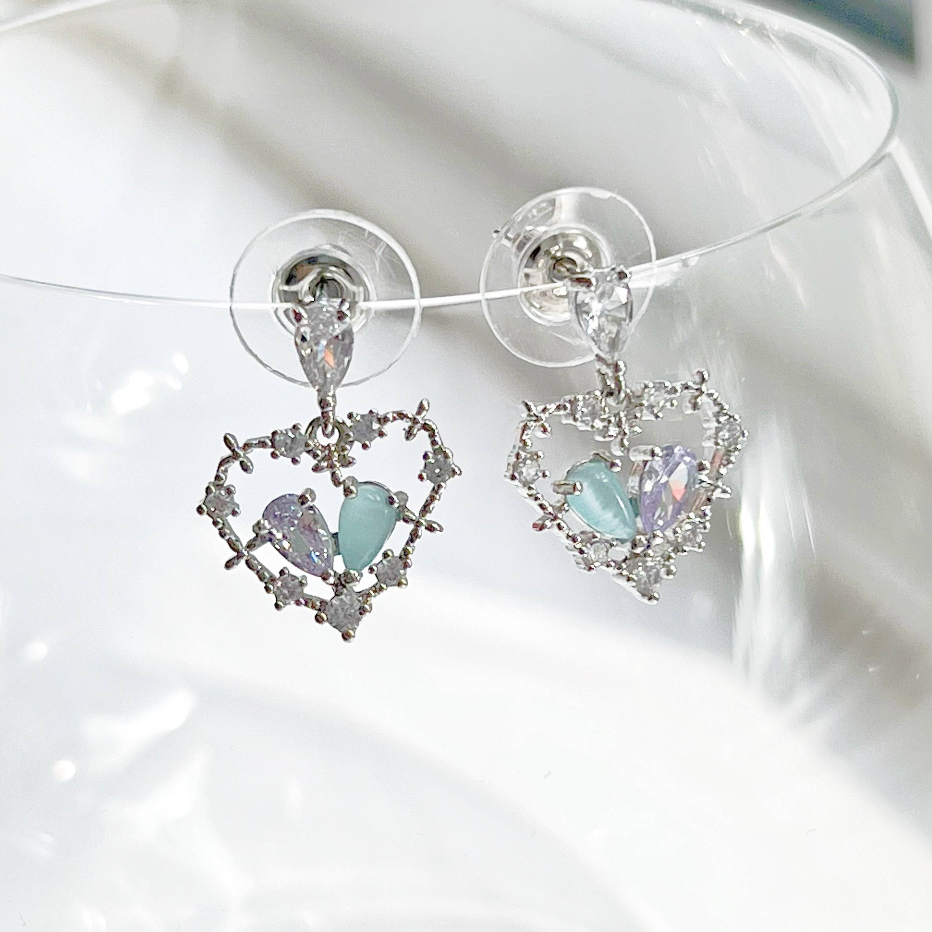 Elegant blue crystal heart drop earrings in sterling silver, showcasing a beautiful heart shape design.