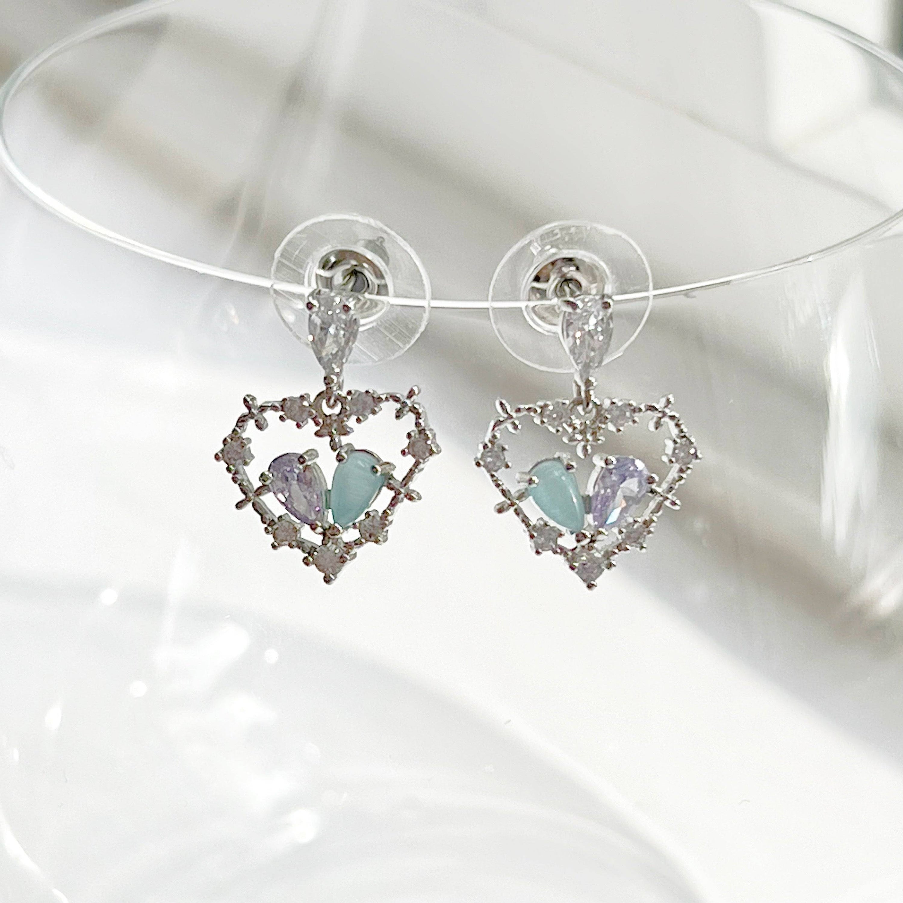 Elegant blue crystal heart drop earrings in sterling silver, showcasing a beautiful heart shape design.