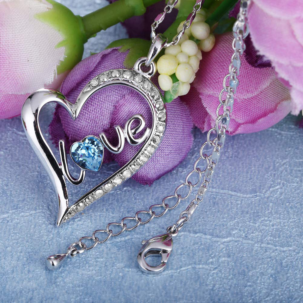 Elegant Blue Elements Classic Love Heart Necklace featuring 14K white gold plating and blue and white stones, displayed on a soft background.